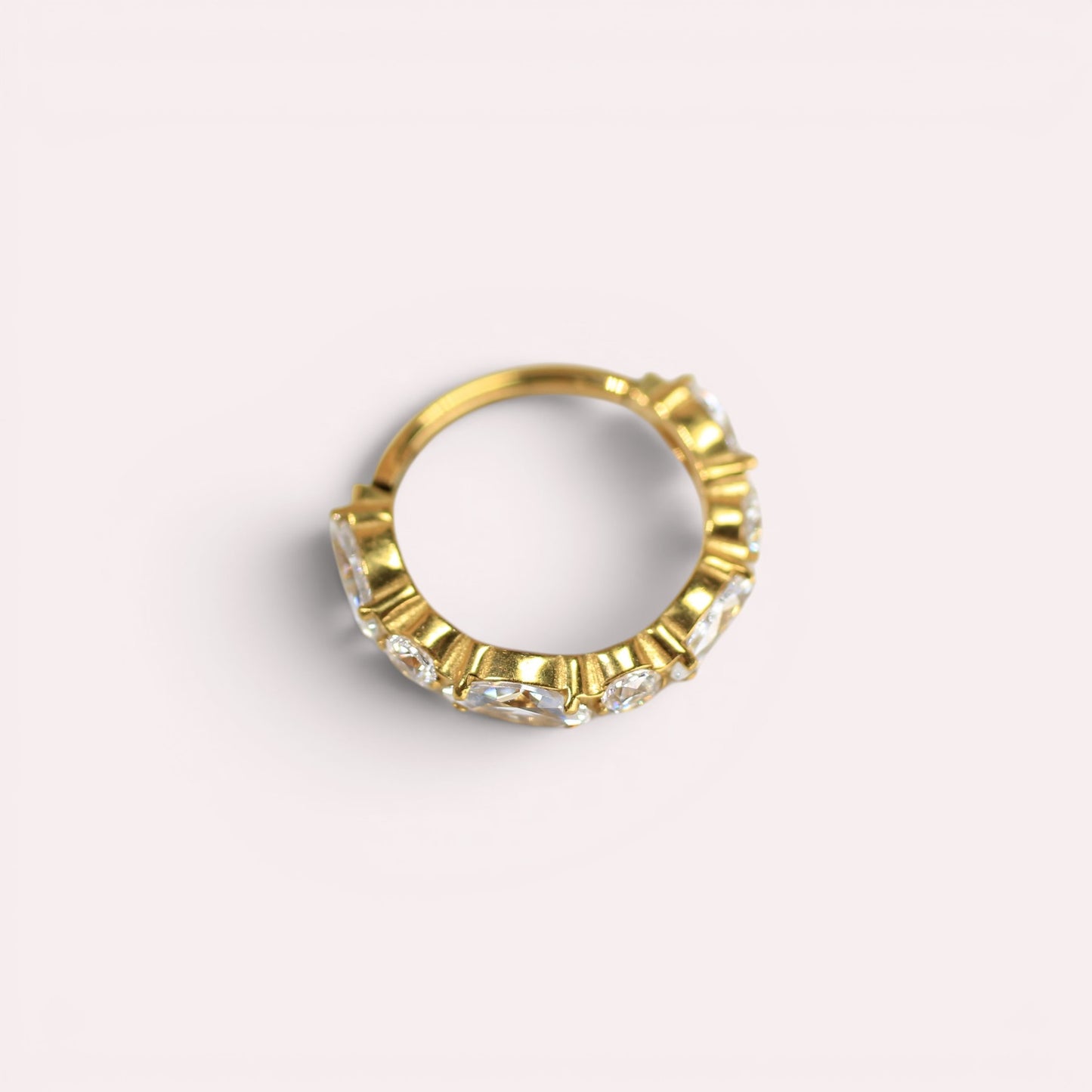 MKBodyJewelry gold titanium hinged nose clicker ring featuring sparkling CZ gems for a minimalist snug fit.