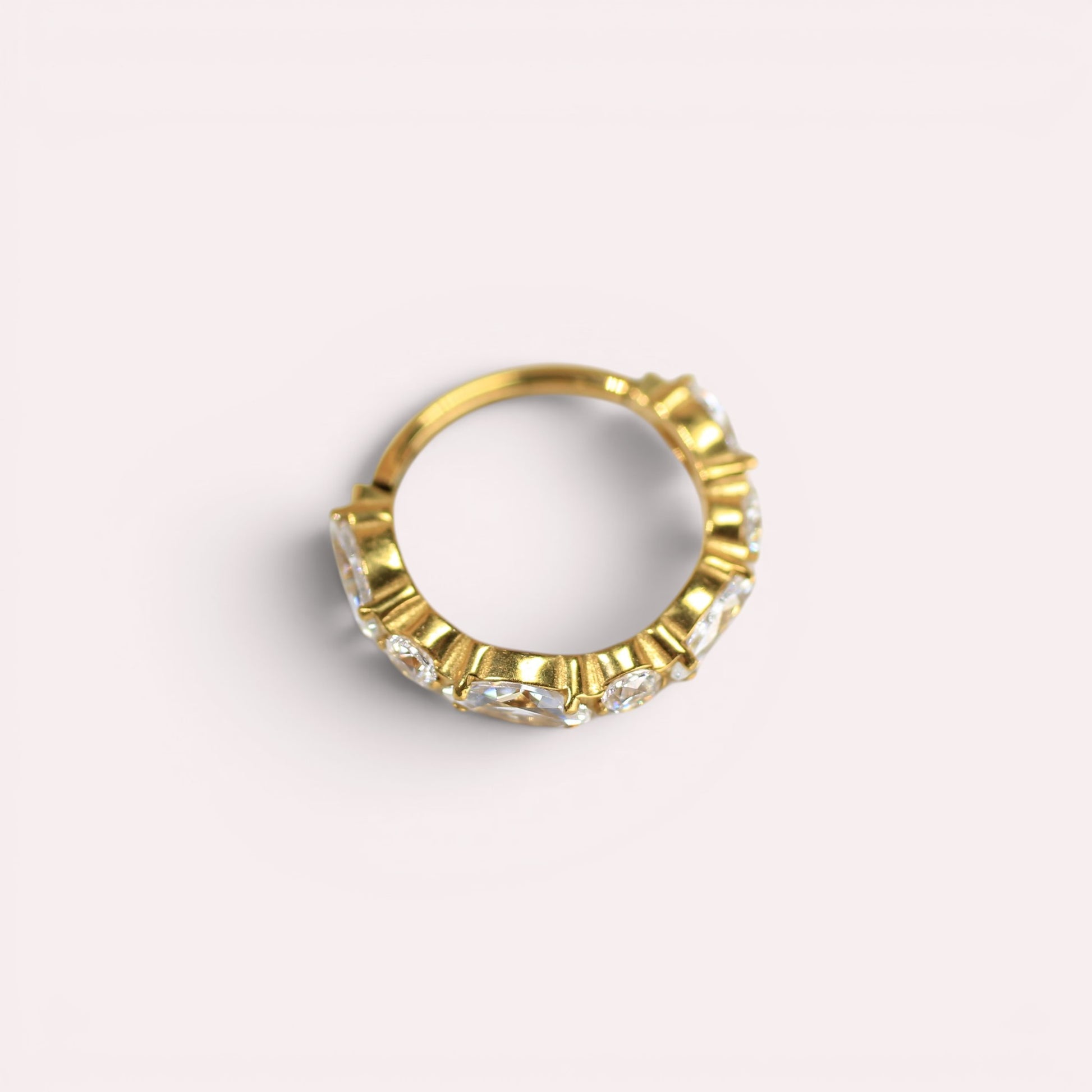 MKBodyJewelry gold titanium hinged nose clicker ring featuring sparkling CZ gems for a minimalist snug fit.
