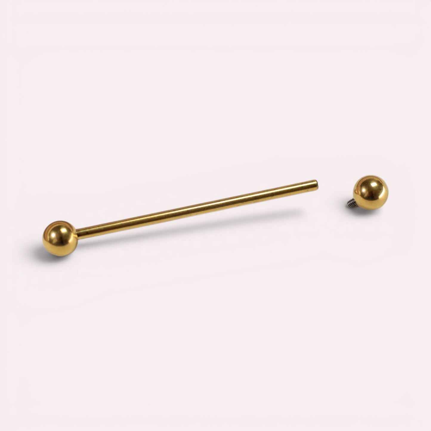 MKBodyJewelry 14G gold titanium industrial barbell with a 35mm length and 5mm threaded ball ends for cartilage piercing