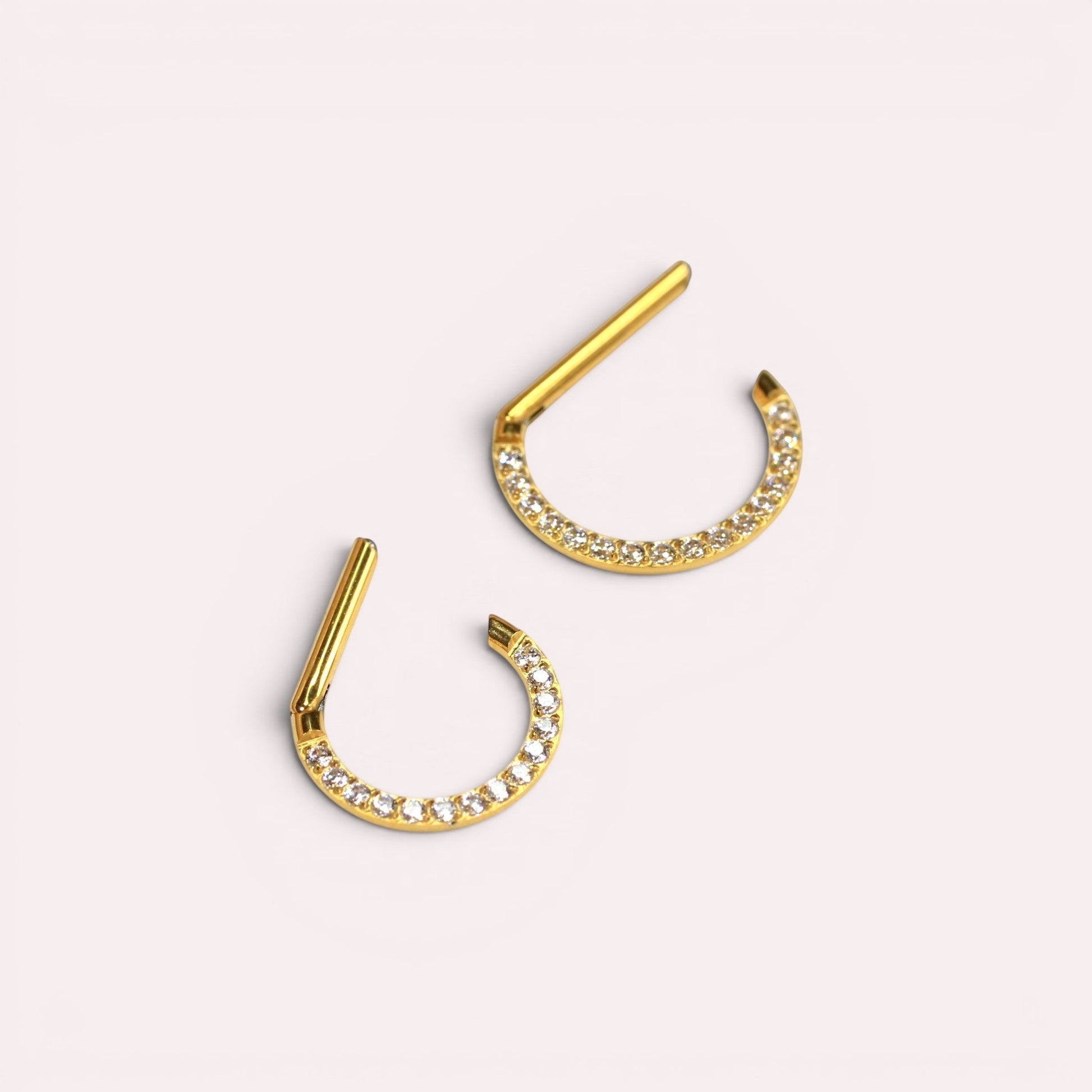 MKBodyJewelry 16G gold titanium septum clicker ring with a dainty line of sparkling gems for daith or nose piercings.