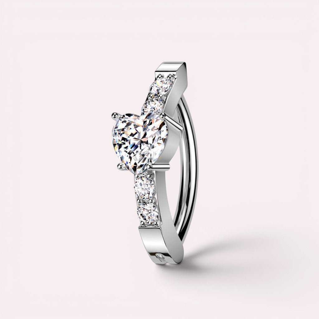 MKBodyJewelry silver surgical steel belly button clicker ring with a heart-shaped CZ stone and paved accents.