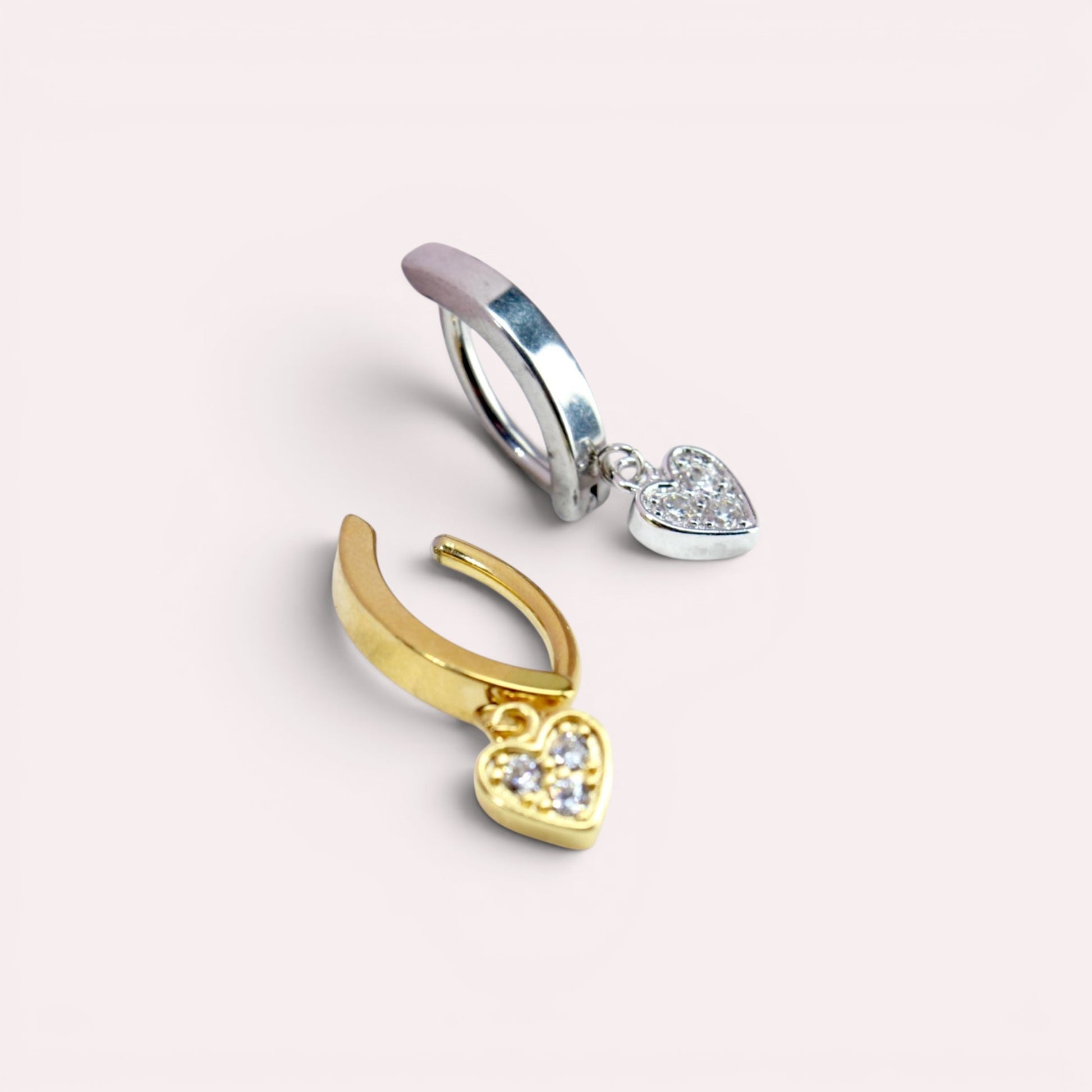 MKBodyJewelry 14g surgical steel belly button rings with dangling heart charms in gold and silver finishes.