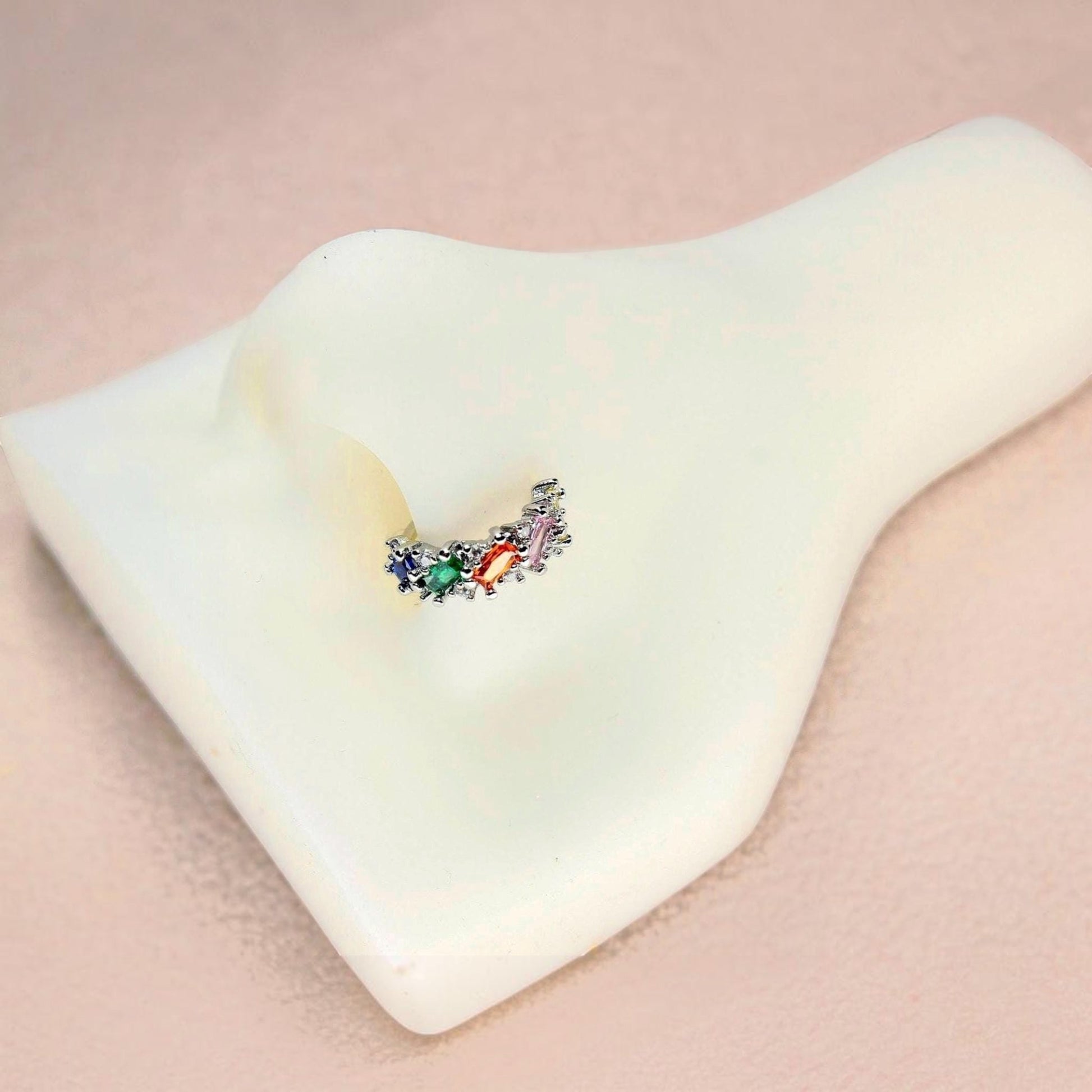 MKBodyJewelry 20g silver nose hoop with multicolor baguette cubic zirconia stones on a white mannequin nose