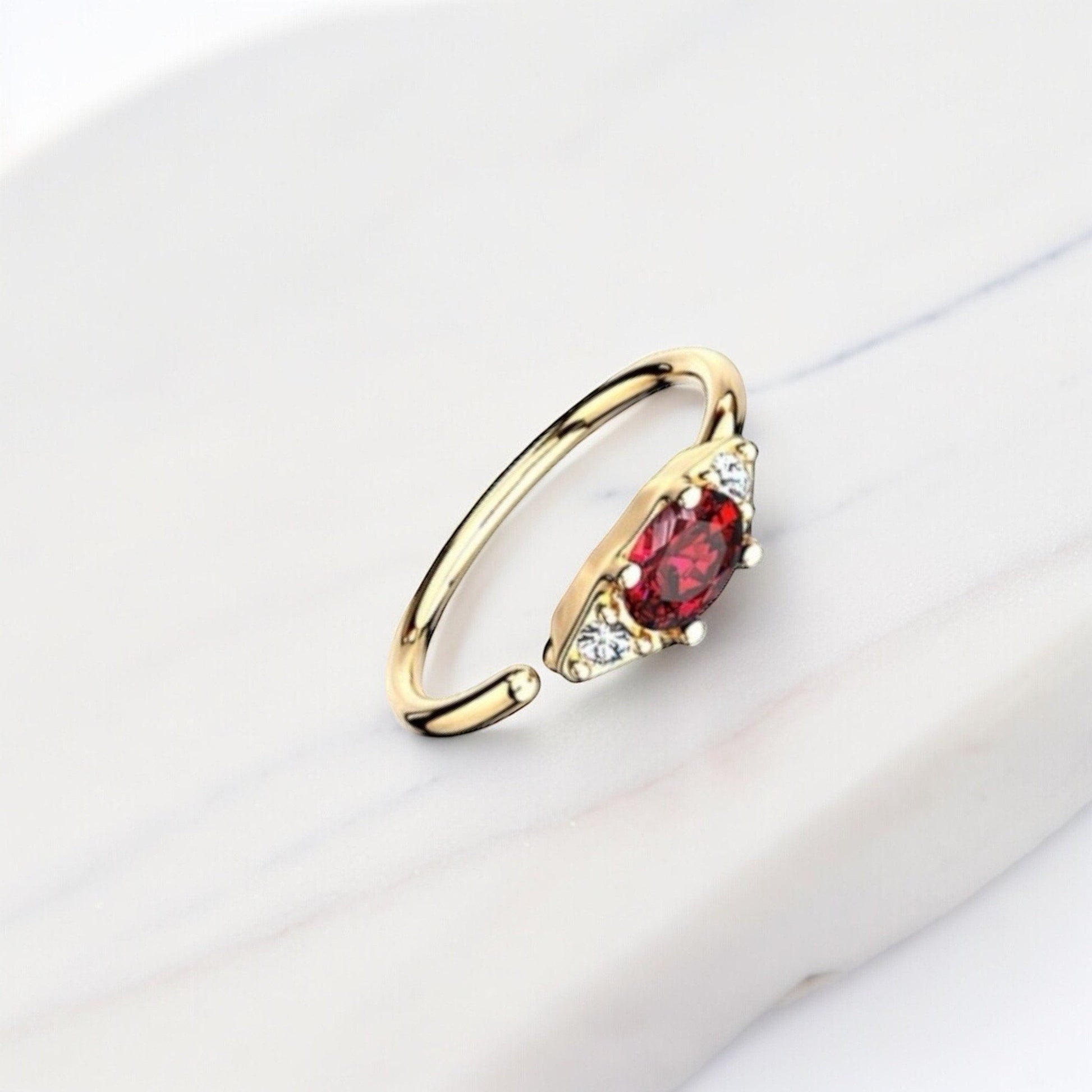MKBodyJewelry 20g gold nose hoop ring with red oval gem and clear accent stones. Bendable for nose or cartilage.