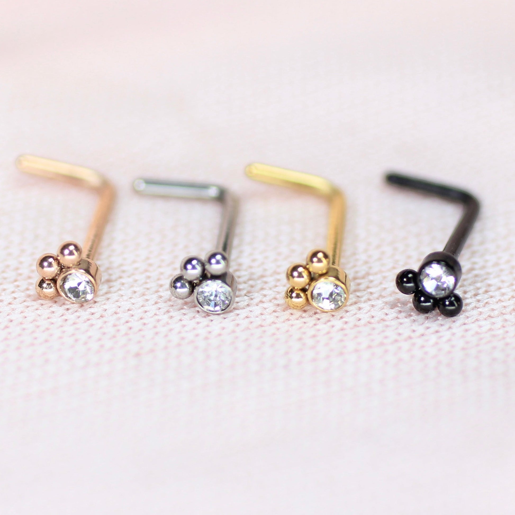 MKBodyJewelry 20G L-shape stainless steel nose studs with dainty paw print designs and clear crystals in four colors