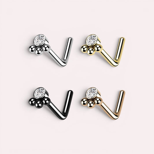 MKBodyJewelry 20G stainless steel paw print L-shape nose studs in silver, gold, black, and rose gold with crystals.