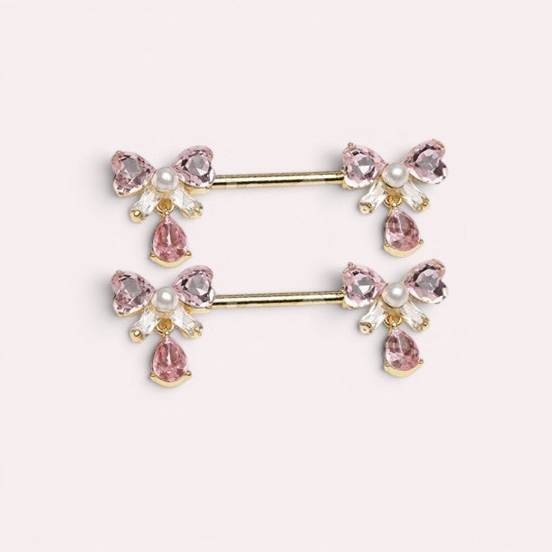 MKBodyJewelry 14g gold surgical steel nipple ring with pink bow-tie charms and dangling pink teardrop gems.