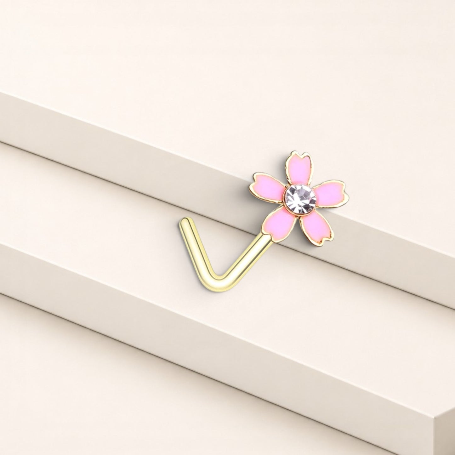 MKBodyJewelry dainty pink flower nose stud with a clear crystal center and gold L-shaped surgical steel post.