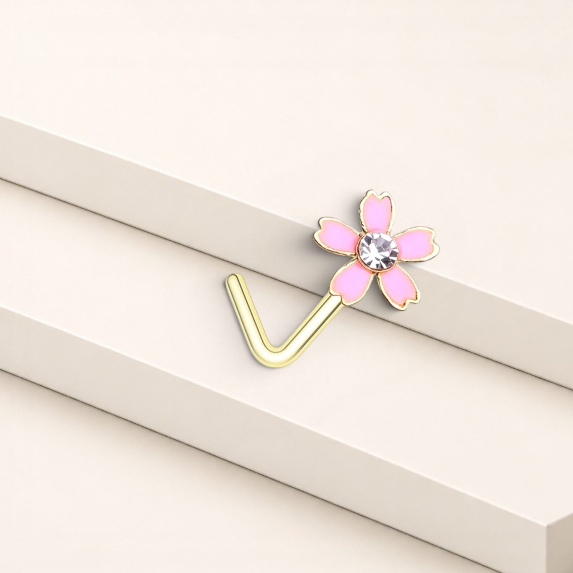 MKBodyJewelry dainty pink flower nose stud with a clear crystal center and gold L-shaped surgical steel post.