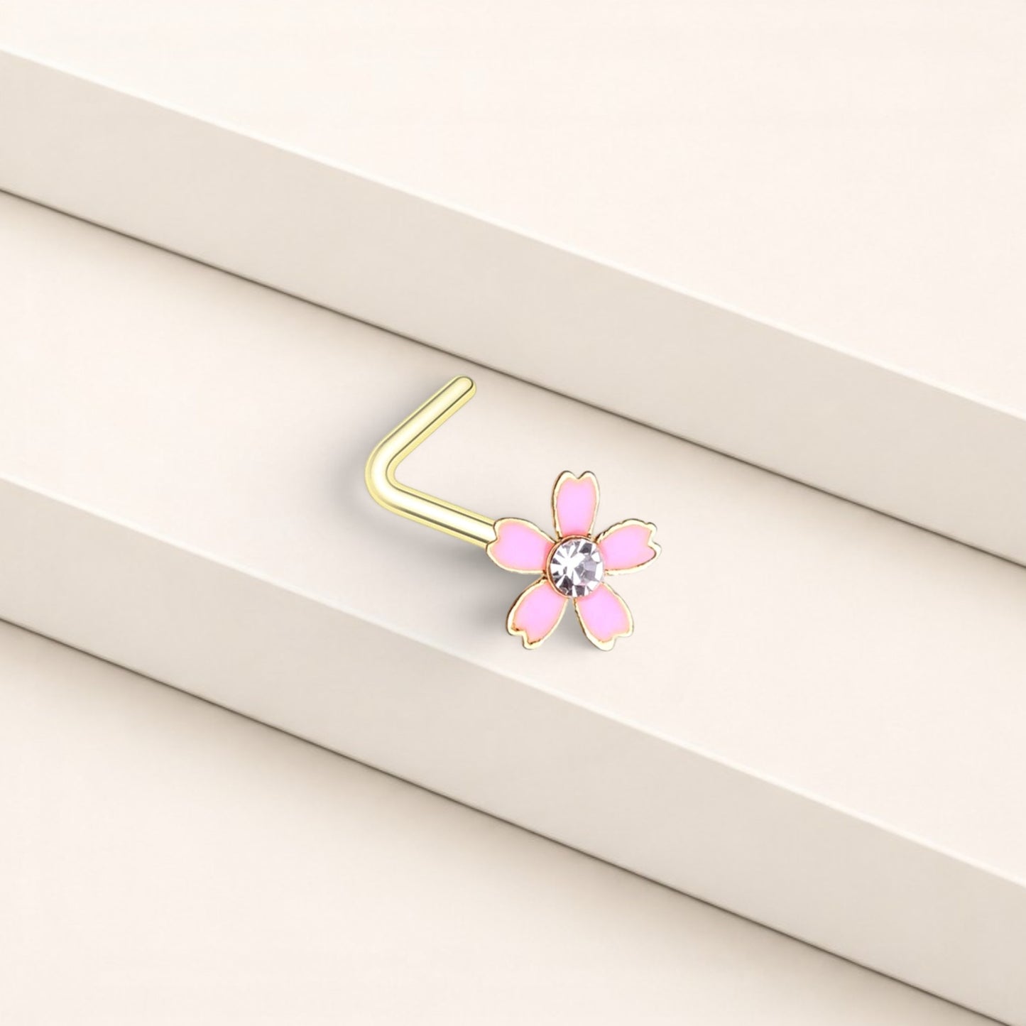 MKBodyJewelry dainty pink flower nose stud in surgical steel with a clear crystal center and L-shape post