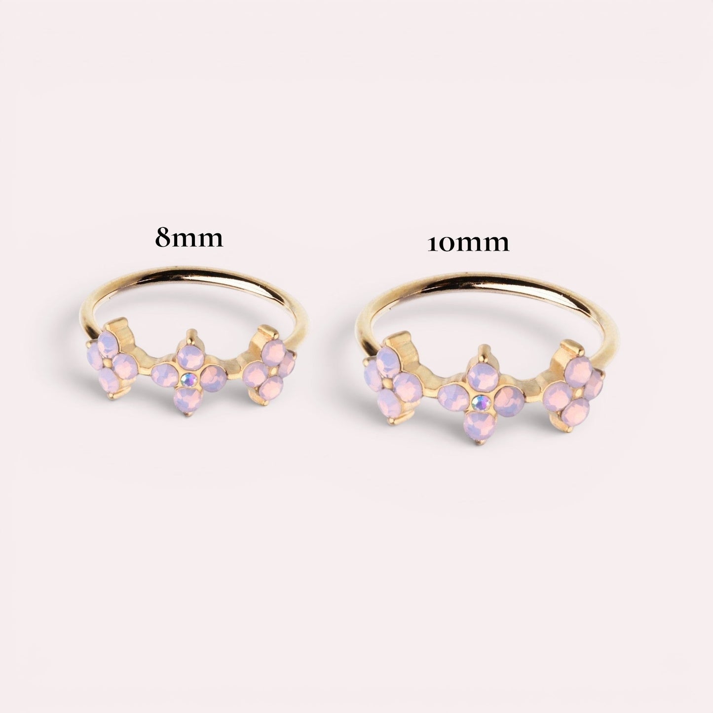 MKBodyJewelry 20g gold surgical steel nose ring featuring a trio of pink opal flowers in 8mm and 10mm sizes.