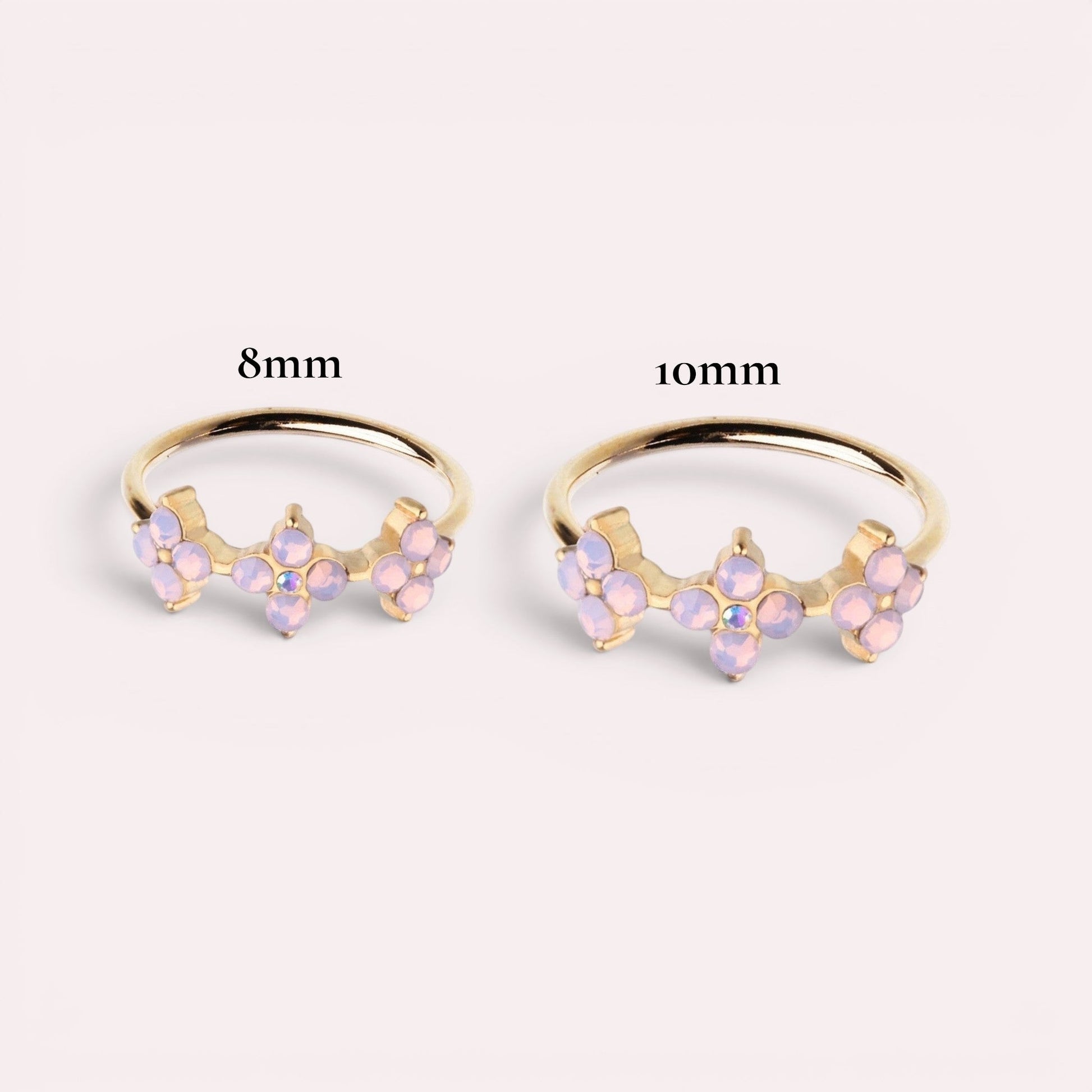 MKBodyJewelry 20g gold surgical steel nose ring featuring a trio of pink opal flowers in 8mm and 10mm sizes.