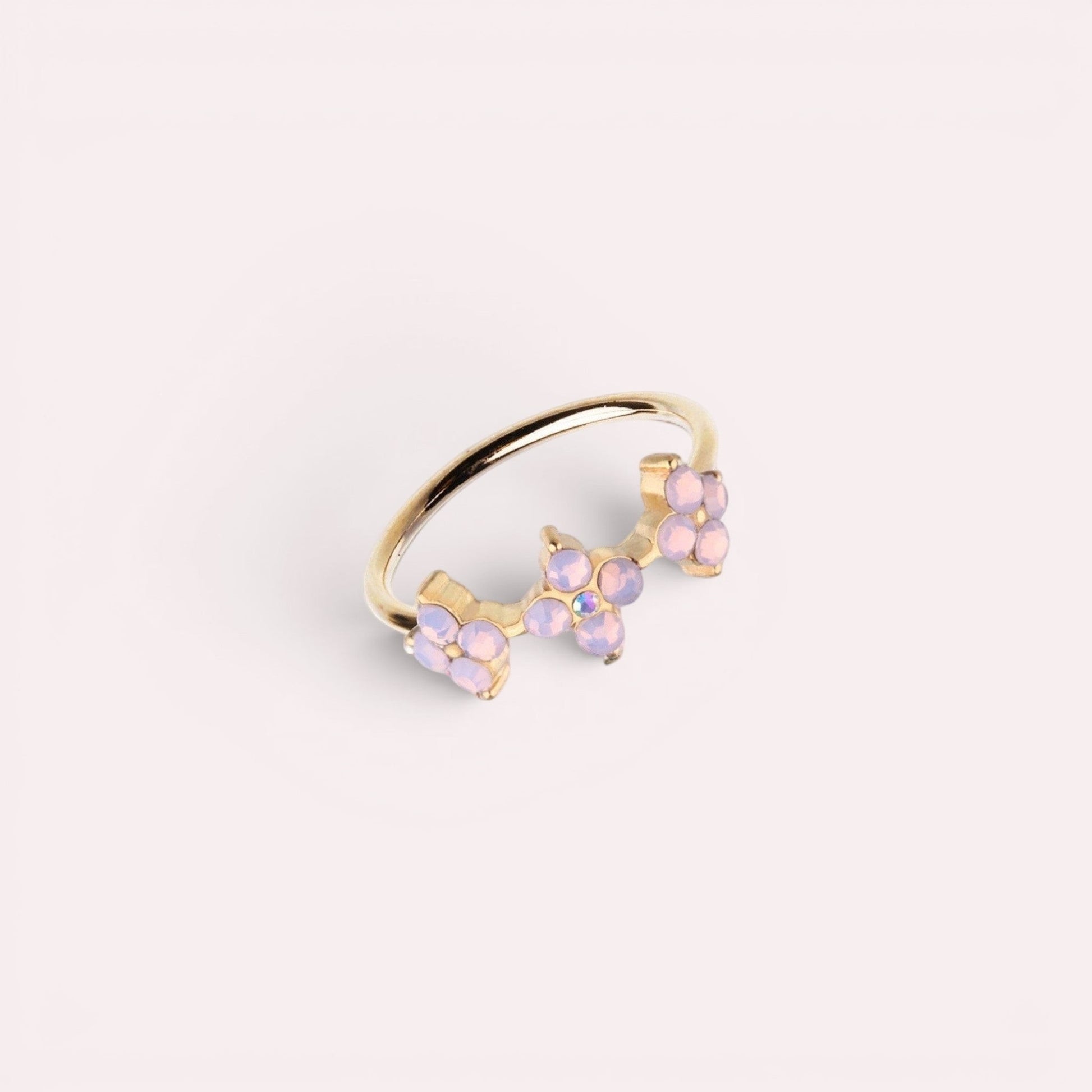 MKBodyJewelry 20g gold surgical steel nose hoop featuring three delicate pink opal flower accents for piercings.