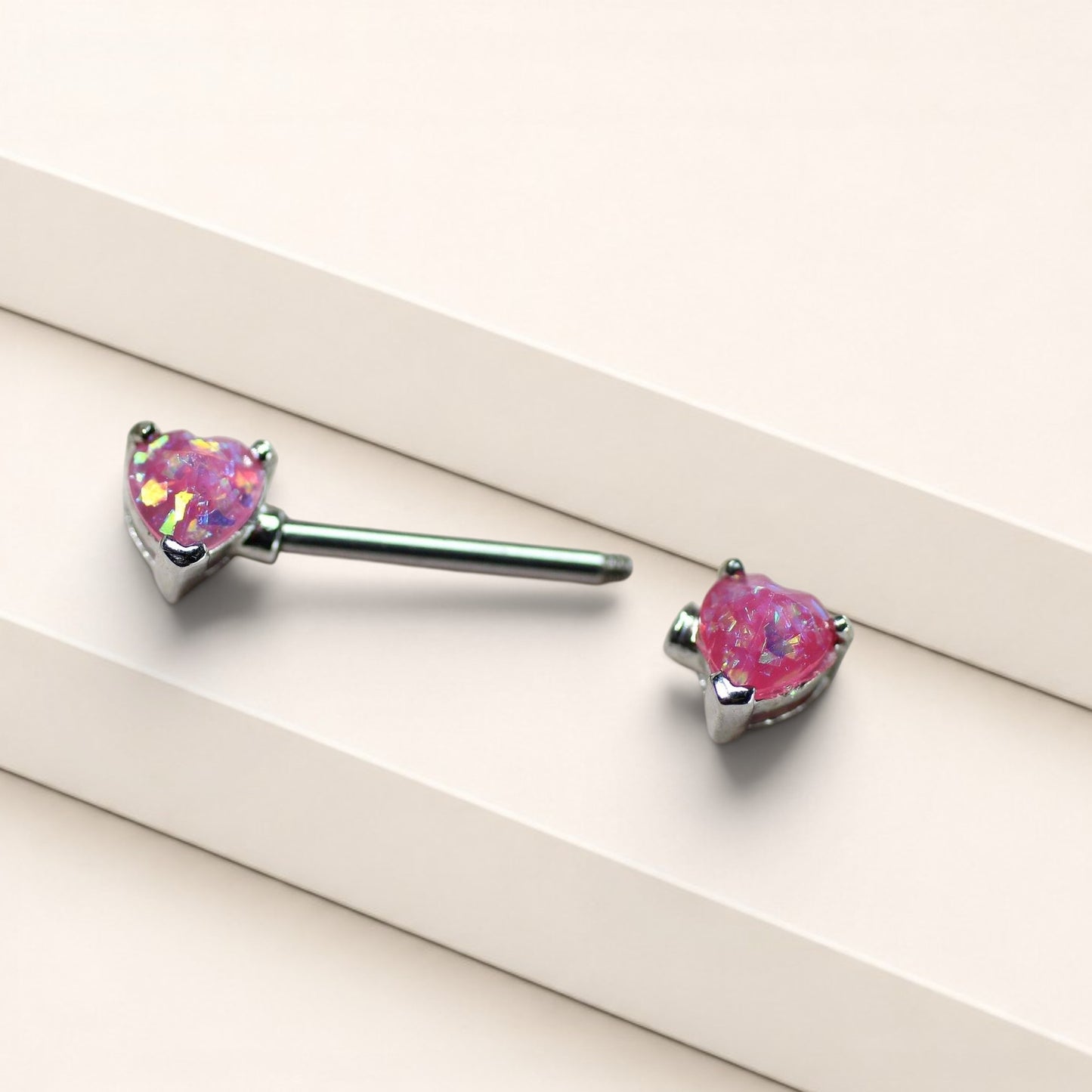 MKBodyJewelry 14g surgical steel nipple rings featuring pink glitter opal heart ends in a pair.