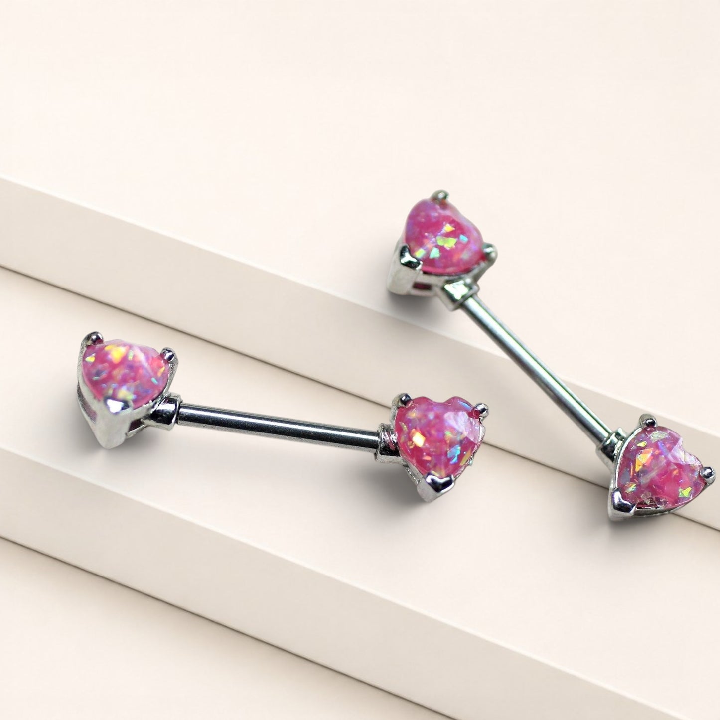 MKBodyJewelry 14g surgical steel nipple rings featuring pink glitter opal heart ends in a pair