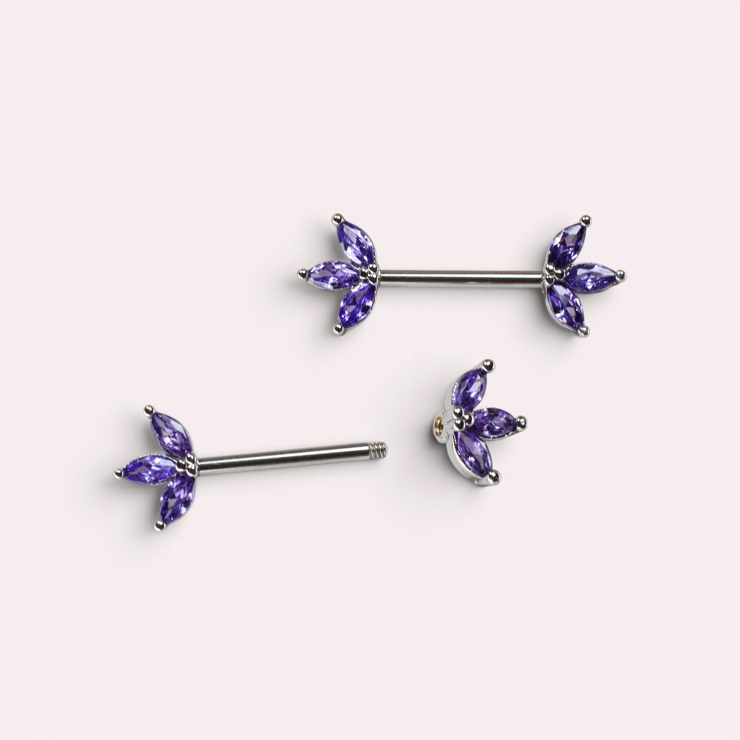 MKBodyJewelry 14G surgical steel nipple barbells featuring purple marquise lotus leaf gem petals in a pair.