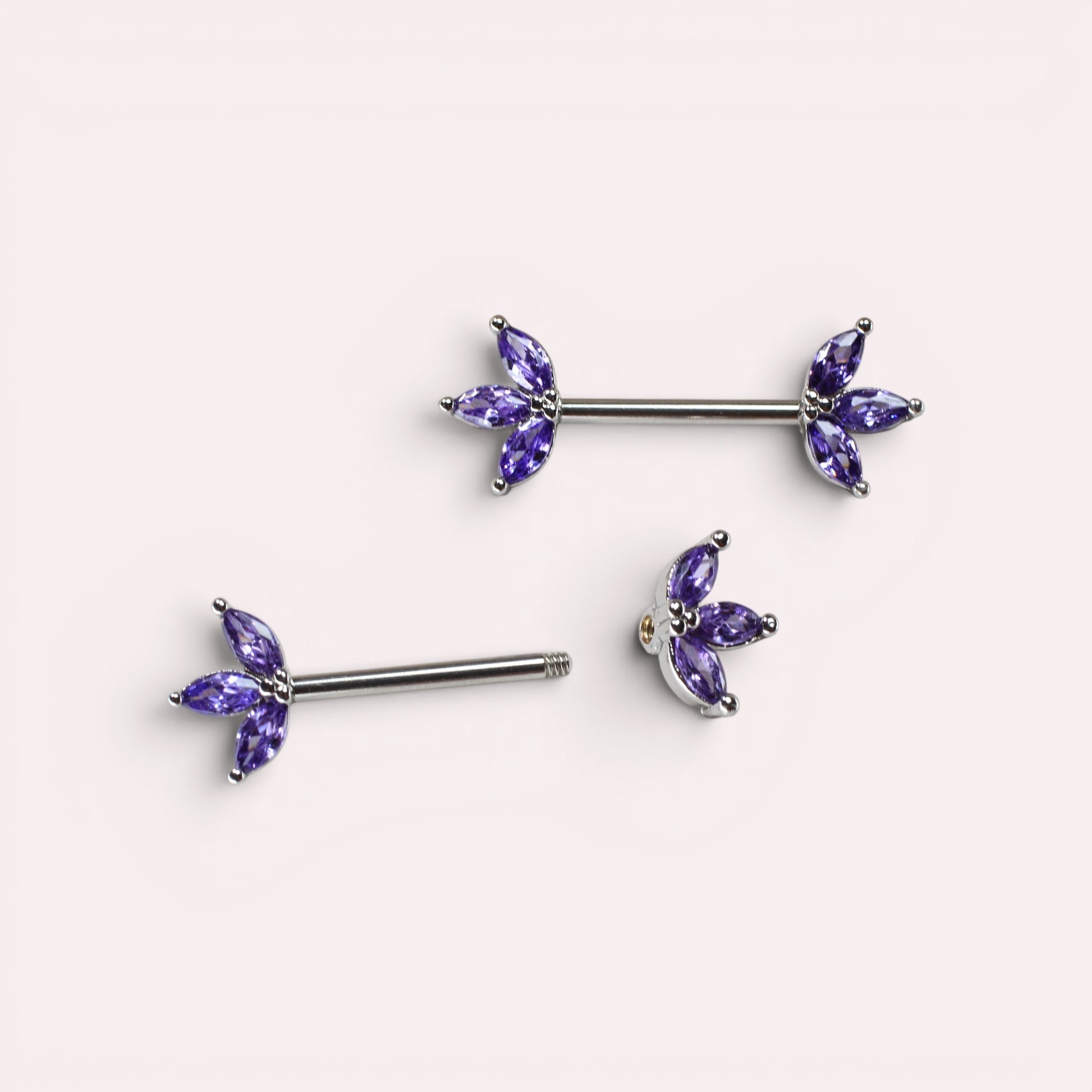 MKBodyJewelry 14G surgical steel nipple barbells featuring purple marquise lotus leaf gem petals in a pair.