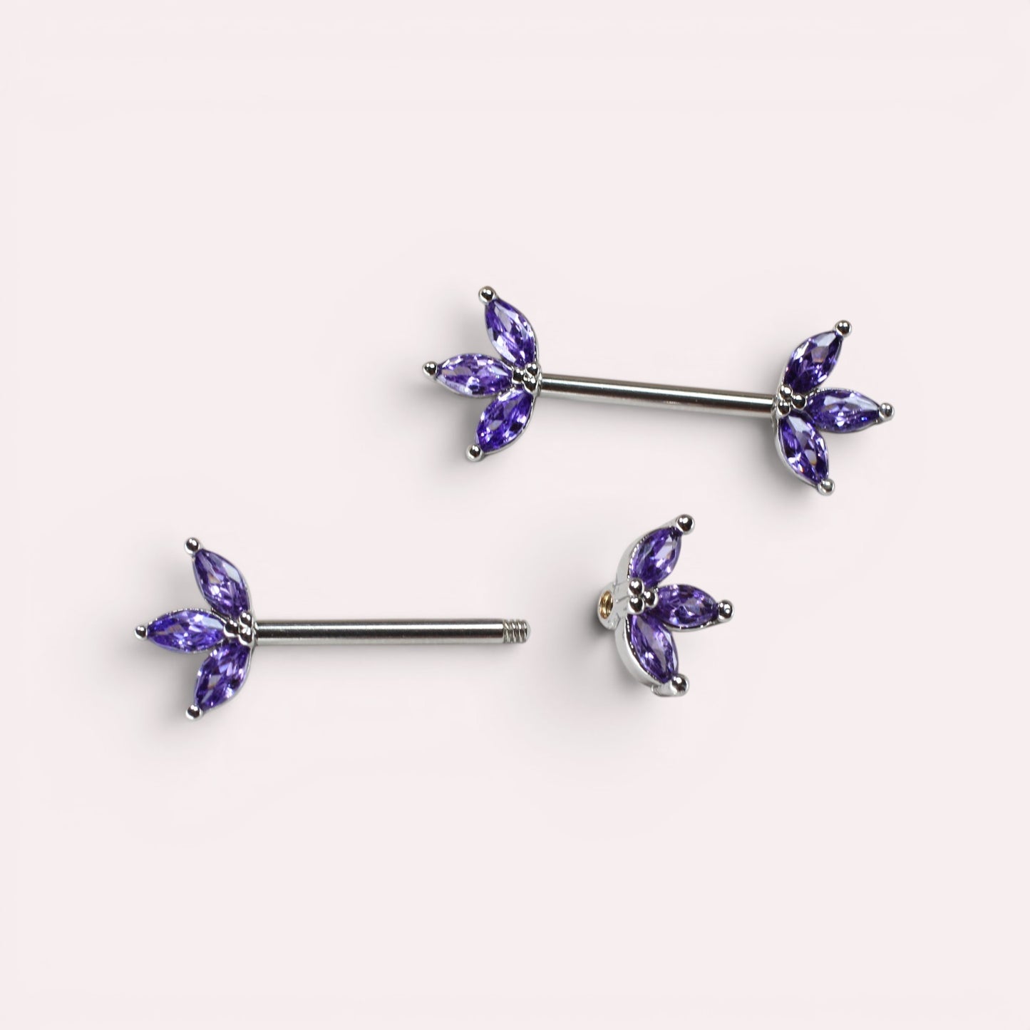 MKBodyJewelry 14G surgical steel nipple barbells featuring purple marquise-cut lotus leaf gem floral petals.