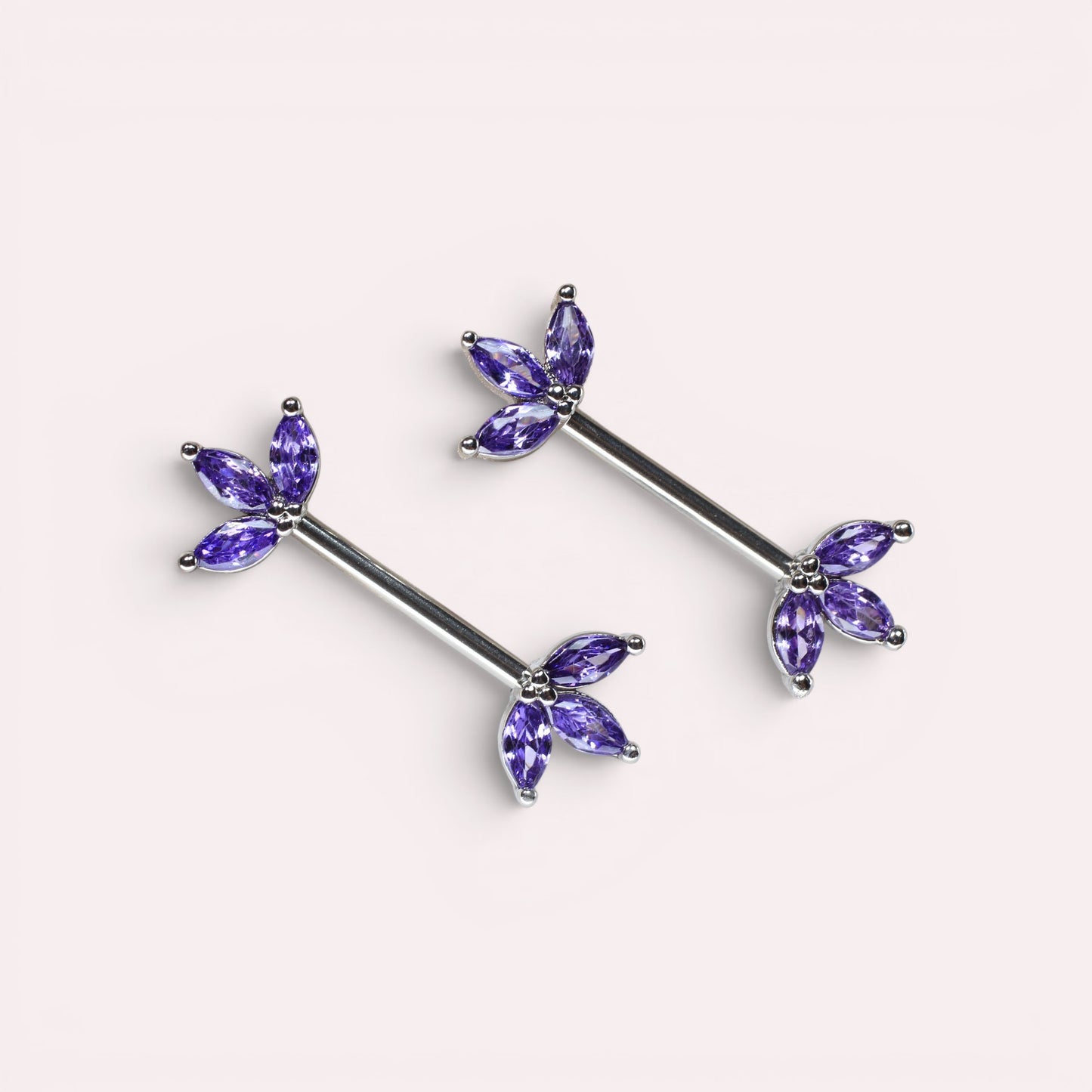 MKBodyJewelry 14G surgical steel nipple barbells featuring purple marquise lotus leaf gems in a pair.