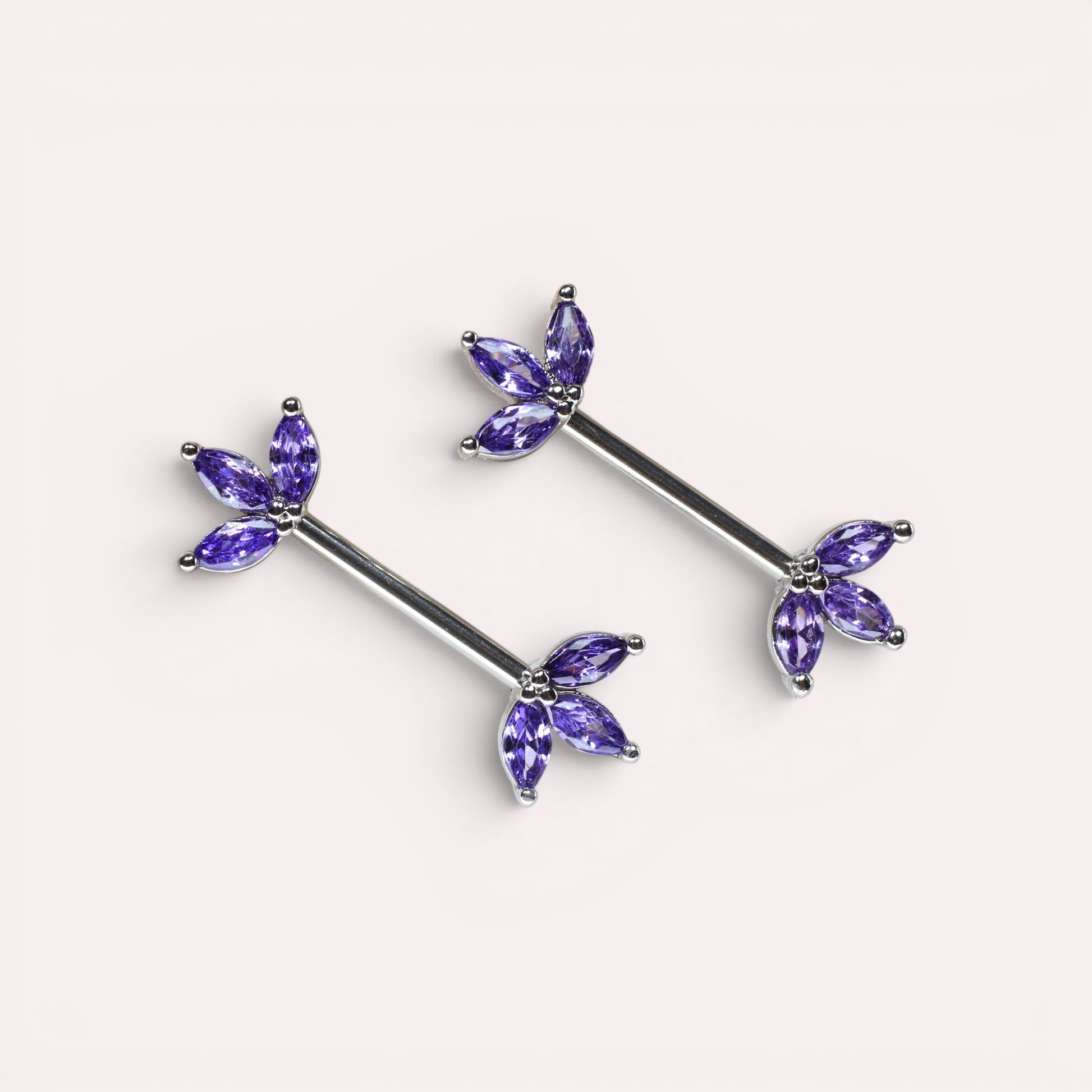 MKBodyJewelry 14G surgical steel nipple barbells featuring purple marquise lotus leaf gems in a pair.