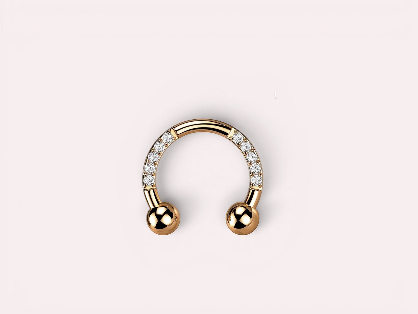 MKBodyJewelry rose gold horseshoe earring with pave CZ sides and ball ends. Implant grade titanium.