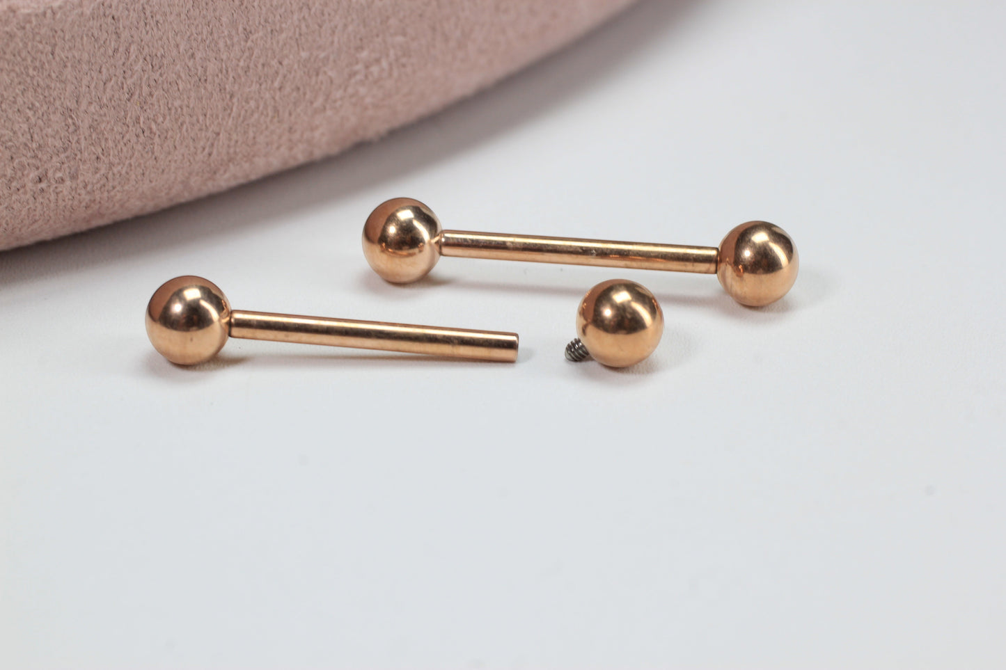 MKBodyJewelry rose gold titanium 14g internally threaded nipple barbell with ball ends. Minimalist design.
