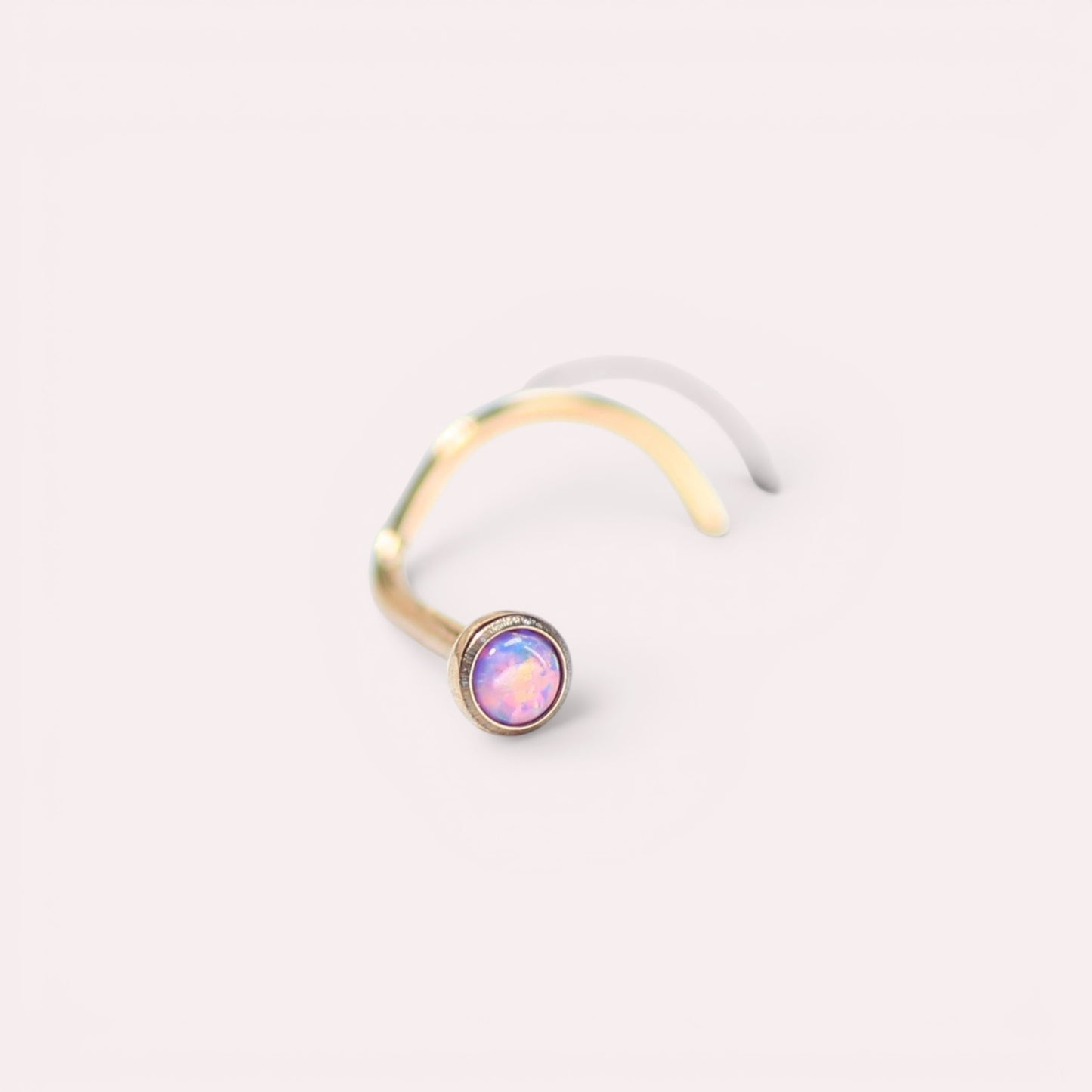MKBodyJewelry rose gold titanium nose stud with a 2.5mm round opal gem and secure corkscrew post for sensitive skin.