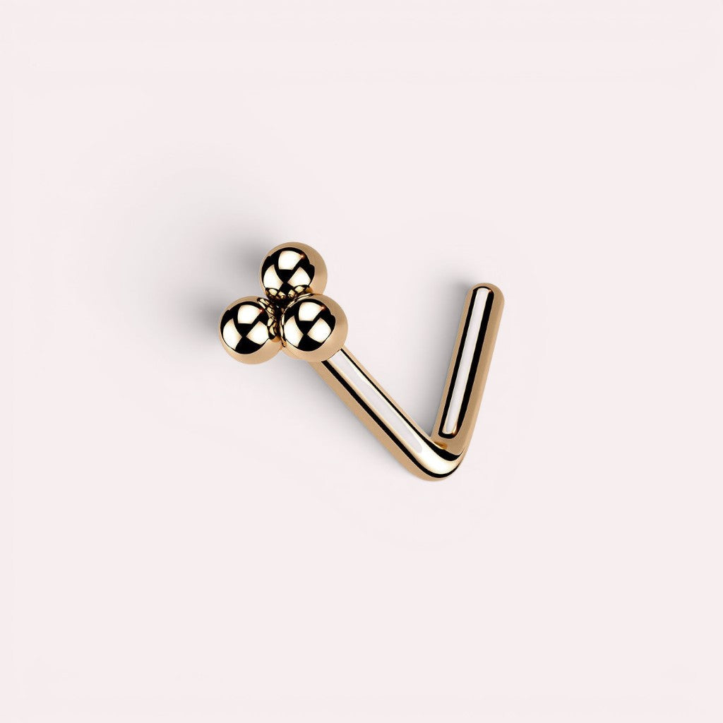 MKBodyJewelry rose gold L-shaped nose stud featuring a minimalist cluster of three polished spheres.