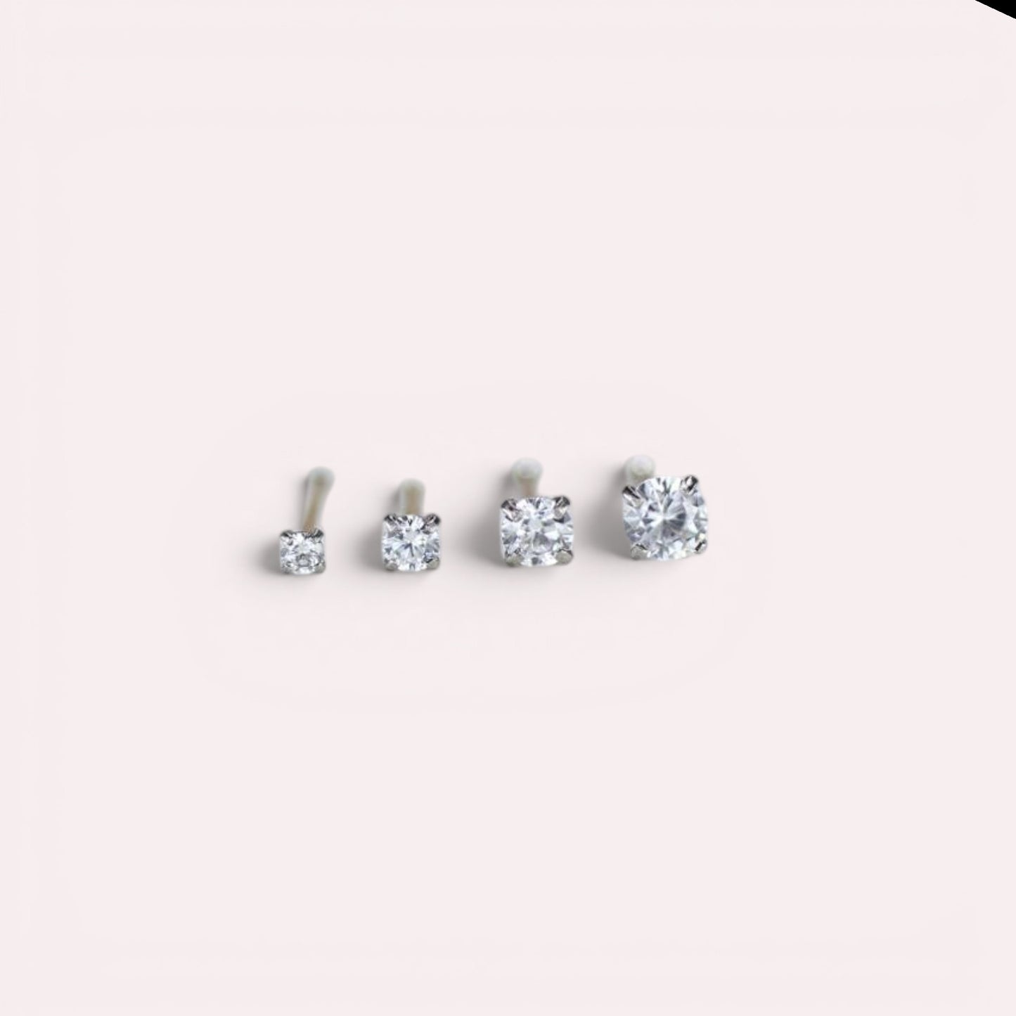MKBodyJewelry set of four round-cut cubic zirconia nose studs in varying sizes with a classic four-prong setting.