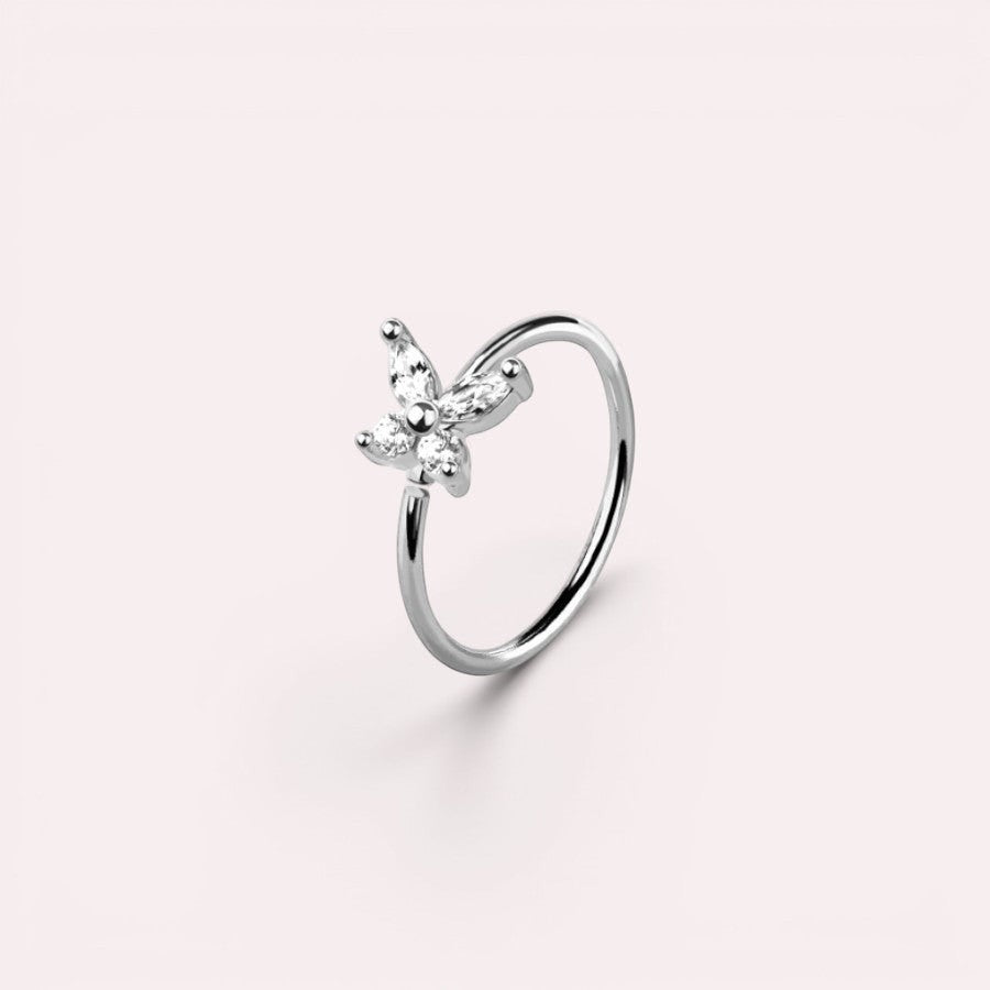 MKBodyJewelry 20g silver surgical steel nose hoop featuring a dainty butterfly charm with clear CZ stones.