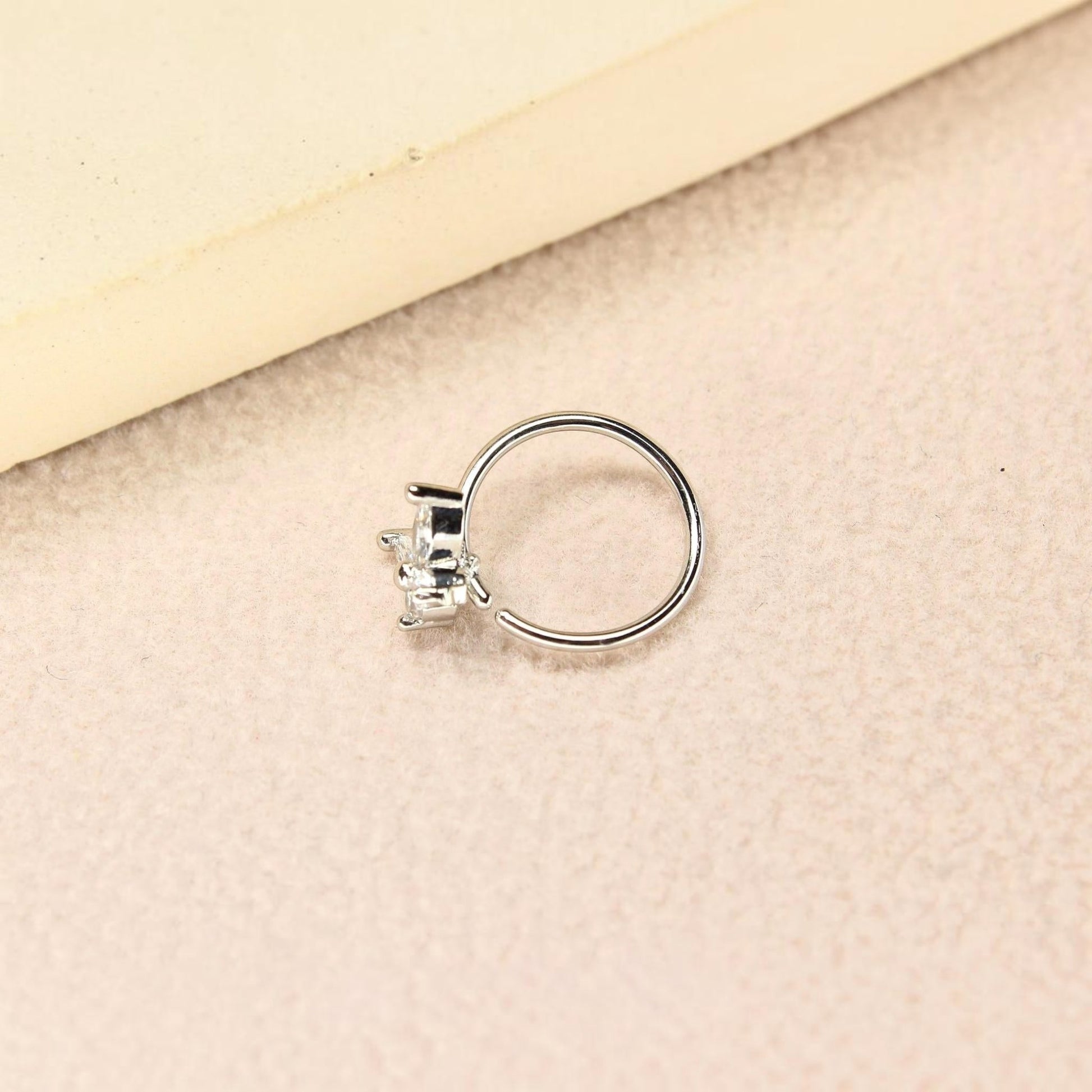 MKBodyJewelry 20g silver surgical steel nose hoop featuring a dainty butterfly charm with clear CZ stones.