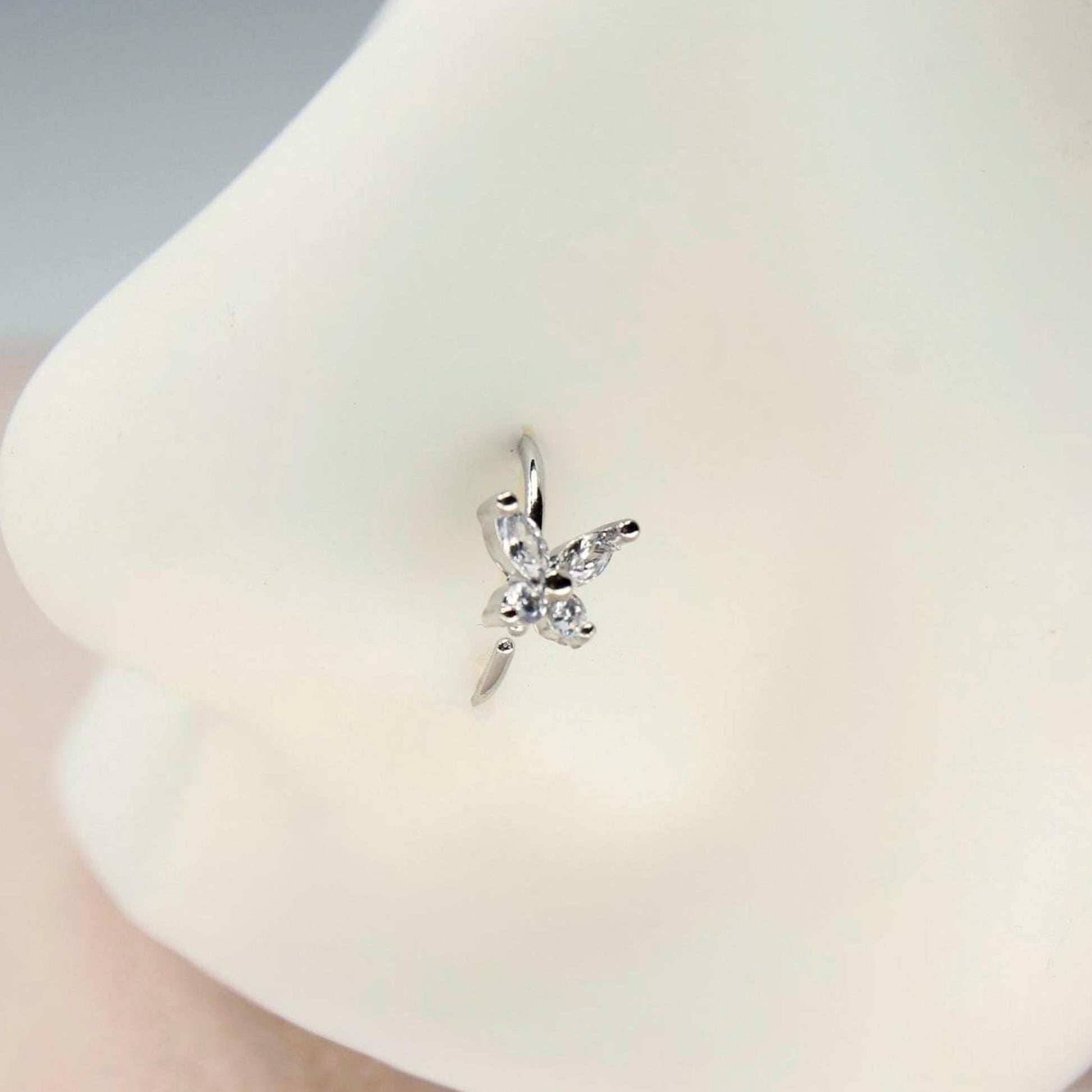 MKBodyJewelry silver butterfly nose hoop ring with clear CZ stones on a mannequin nose