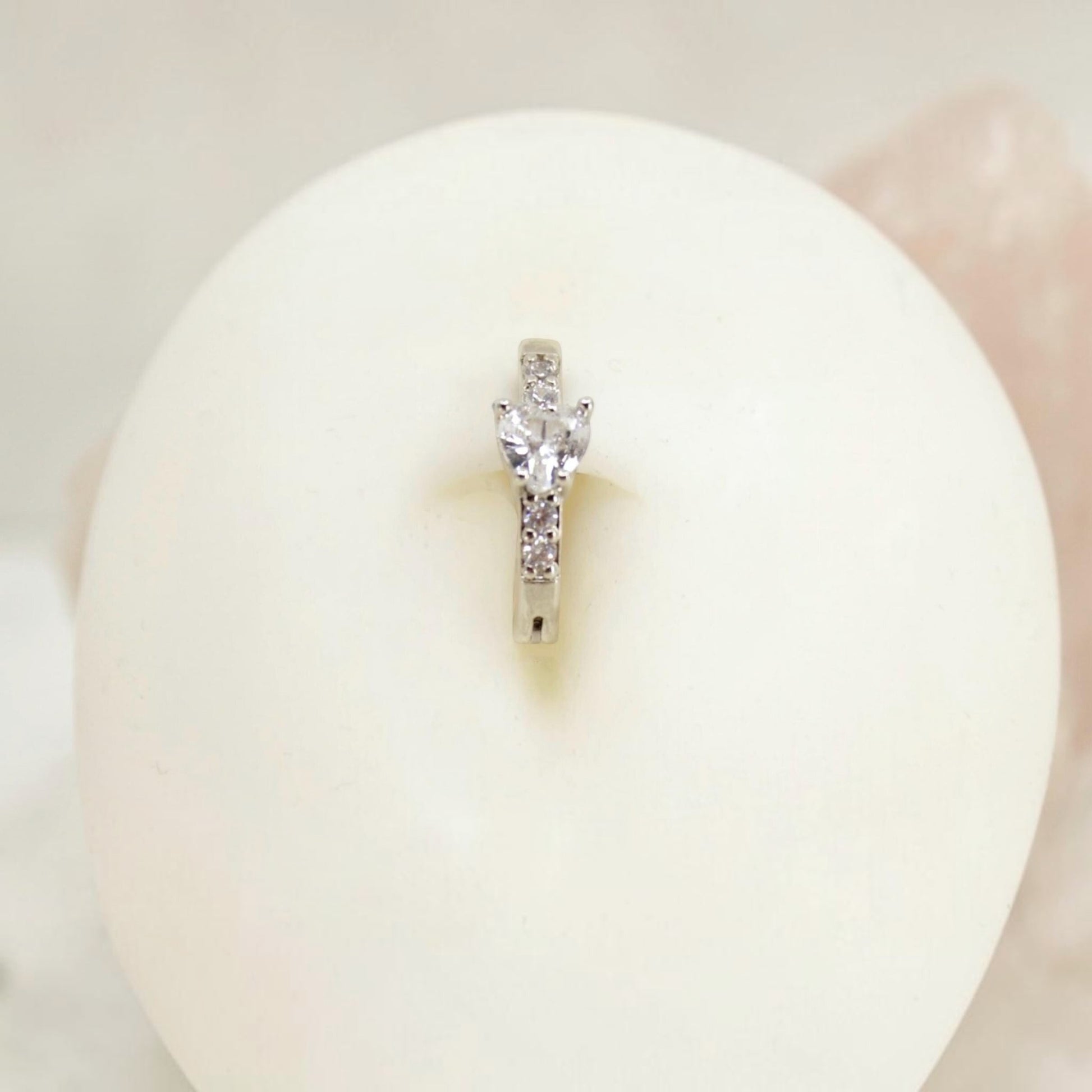 MKBodyJewelry 14G silver surgical steel belly clicker ring with sparkling CZ crystals in a minimalist hoop design.