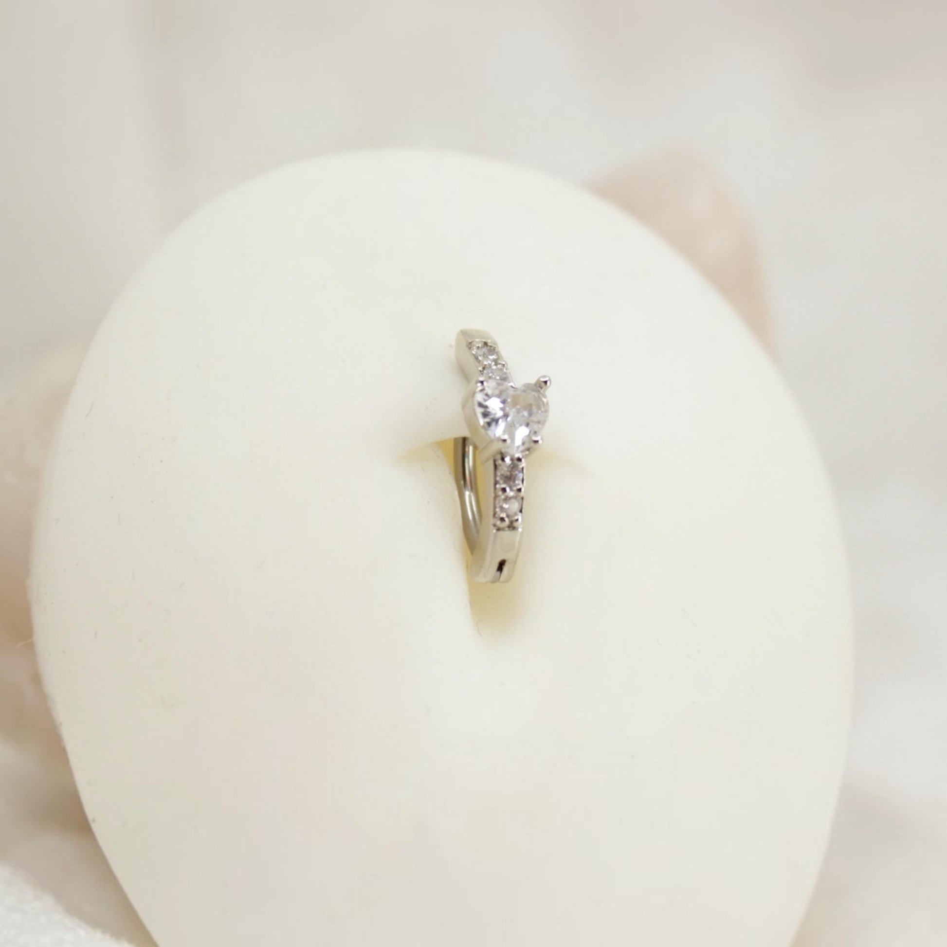 MKBodyJewelry 14G silver surgical steel belly clicker ring with sparkling CZ crystals in a minimalist hoop design.