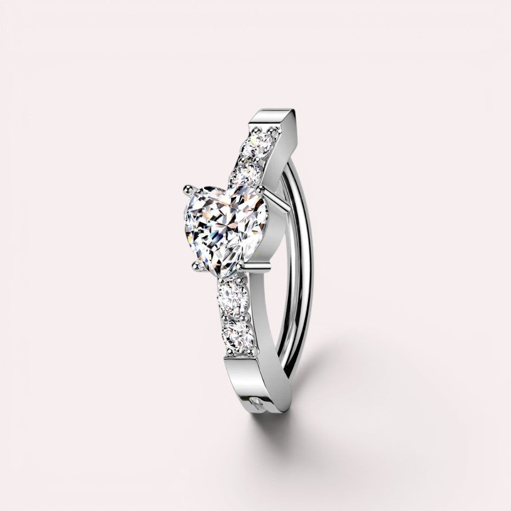 MKBodyJewelry 14G silver surgical steel belly clicker ring featuring a heart-shaped CZ stone and sparkling accents.