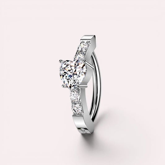 MKBodyJewelry 14G silver surgical steel belly clicker ring featuring a heart-shaped CZ stone and sparkling accents.