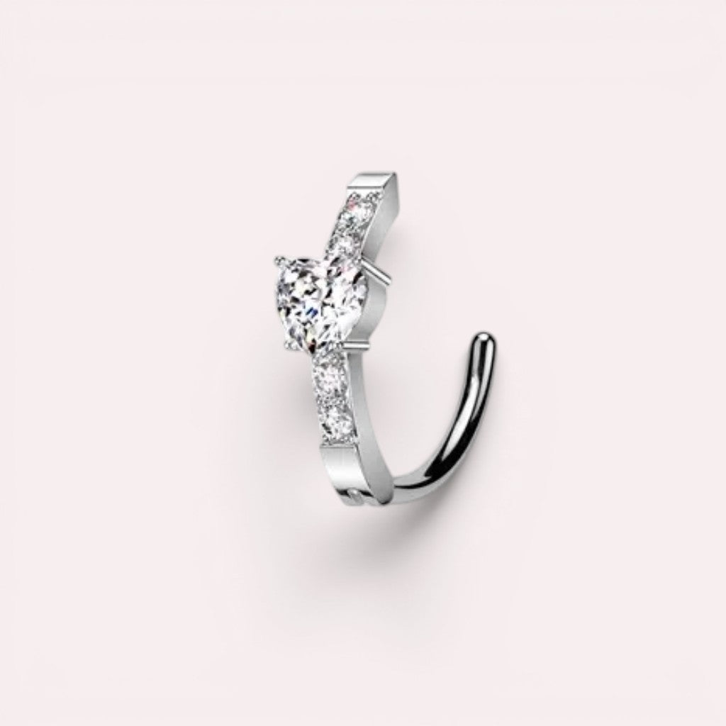 MKBodyJewelry 14G silver belly clicker ring with a heart-shaped CZ crystal and sparkling pave accents.