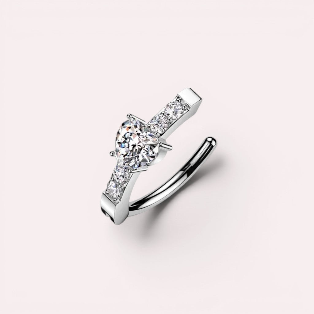 MKBodyJewelry 14G silver belly clicker ring with a heart-shaped CZ crystal and sparkling pave accents.