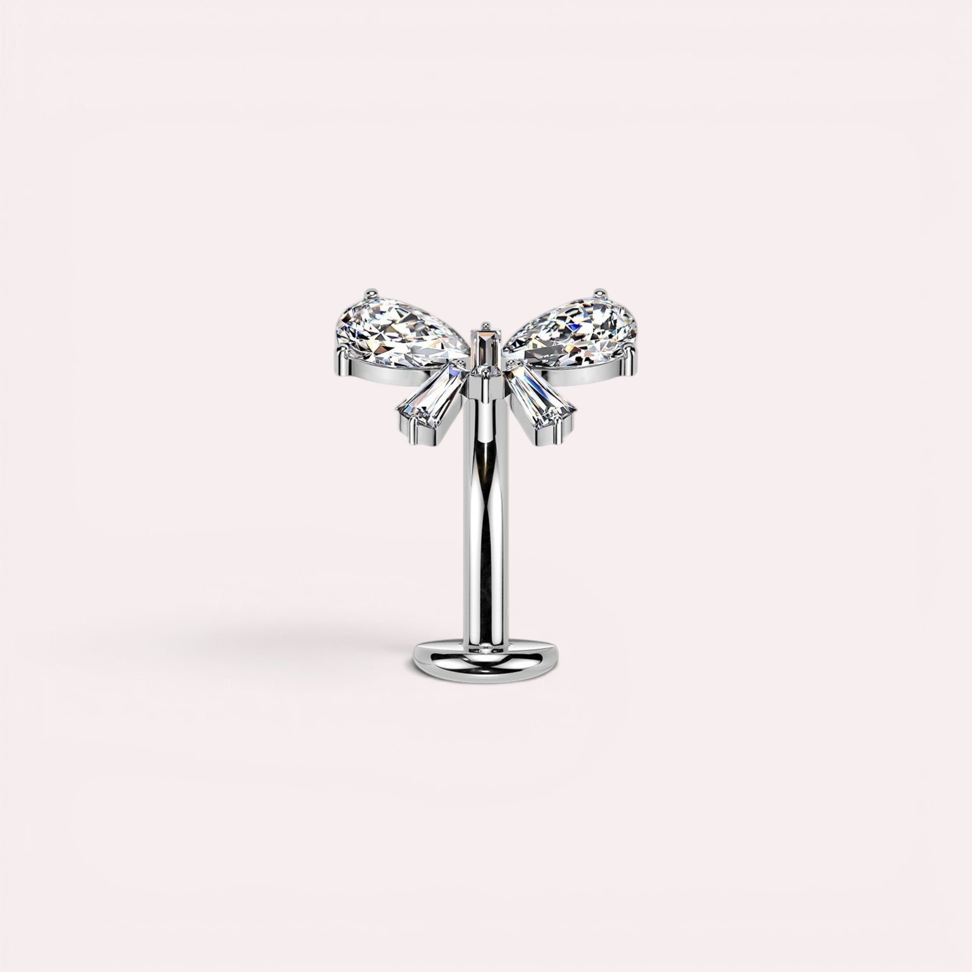 MKBodyJewelry dainty titanium threadless push in belly ring with bow design featuring clear pear and baguette cut cubic zirconia stones.