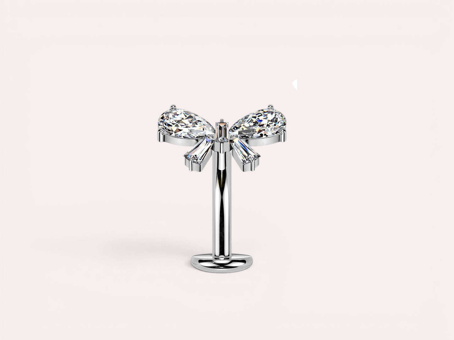 MKBodyJewelry dainty titanium threadless push in belly ring with bow design featuring clear pear and baguette cut cubic zirconia stones.