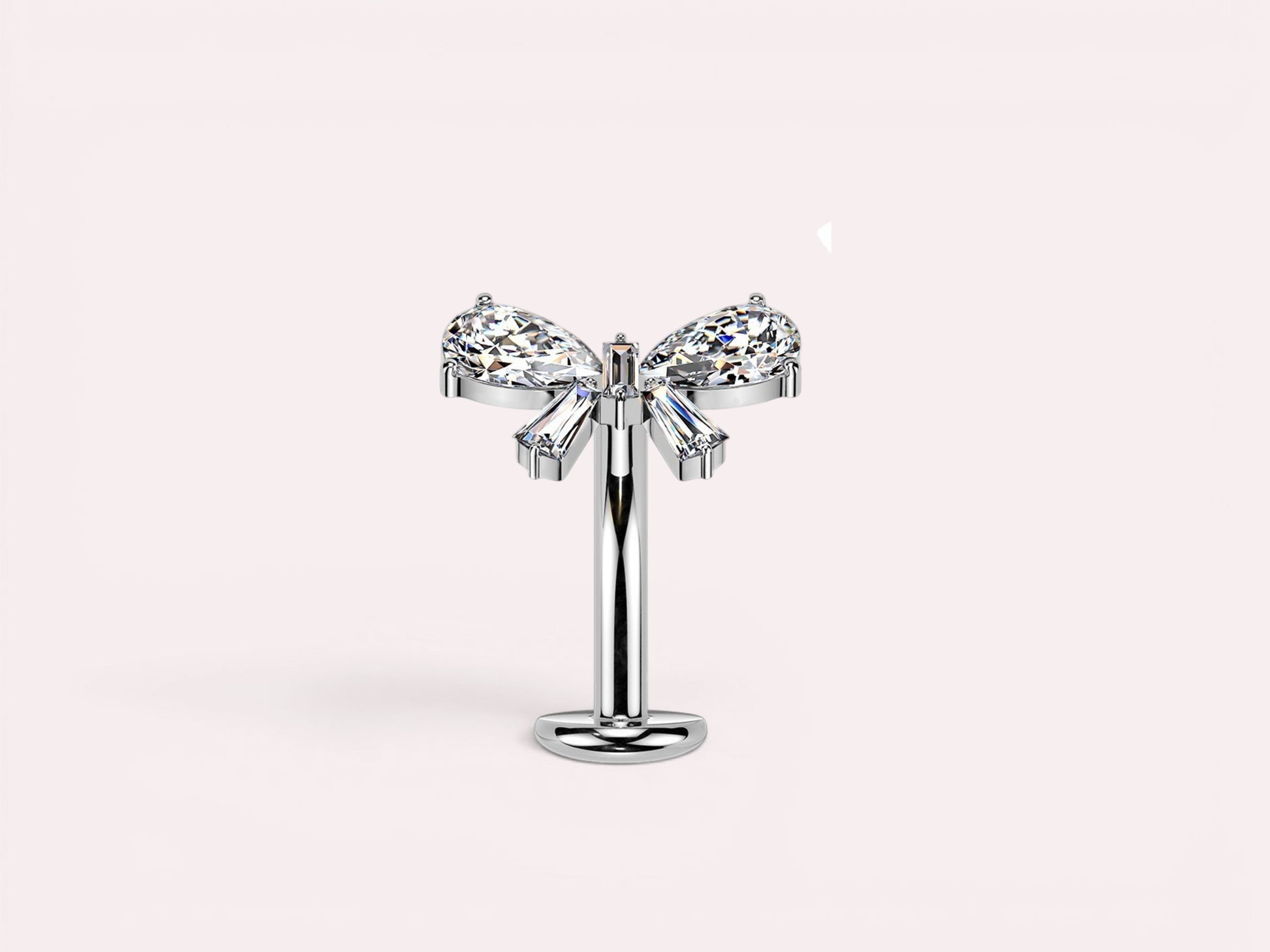 MKBodyJewelry dainty titanium threadless push in belly ring with bow design featuring clear pear and baguette cut cubic zirconia stones.