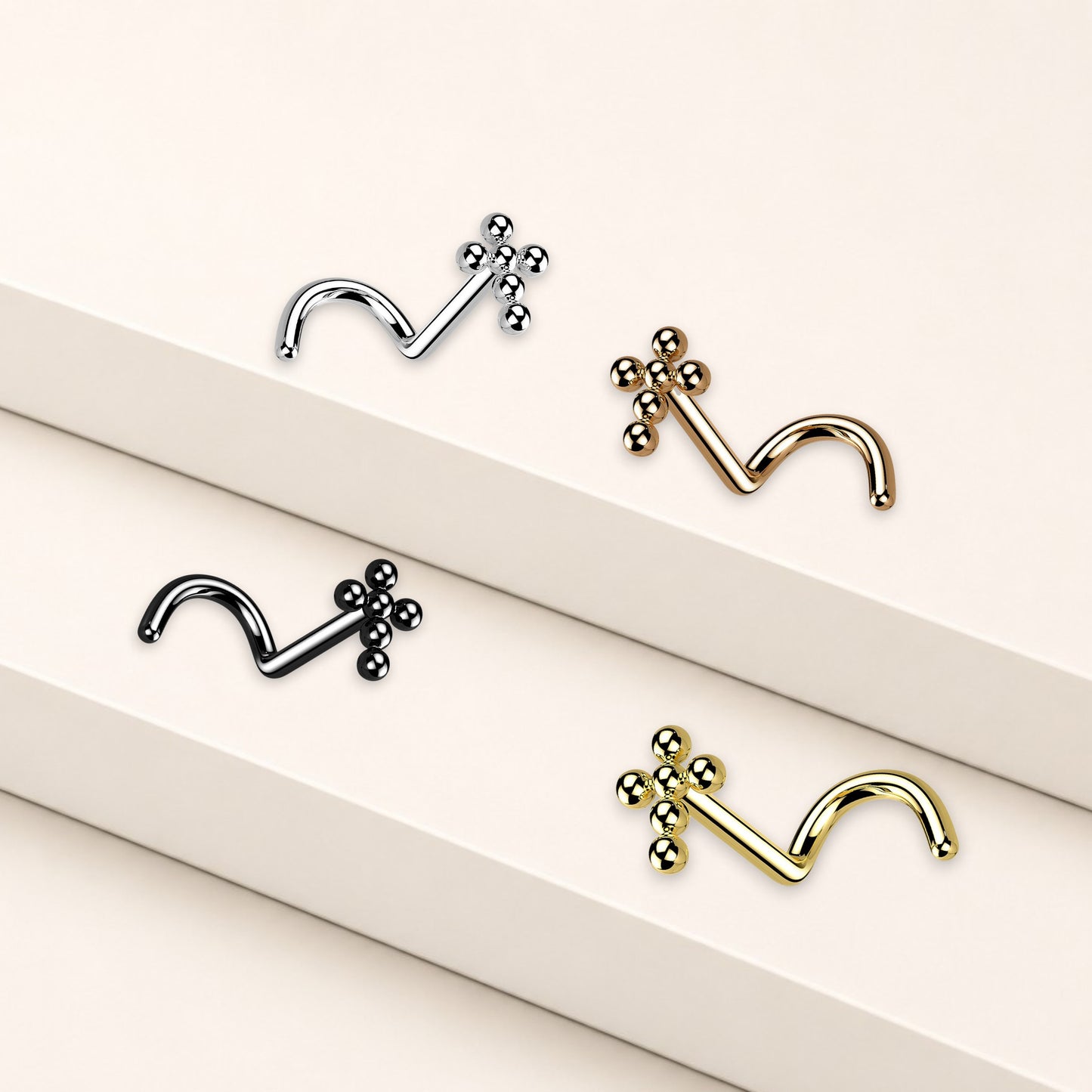 MKBodyJewelry titanium beaded cross nose studs in silver, gold, and black with secure corkscrew S-shaped posts.