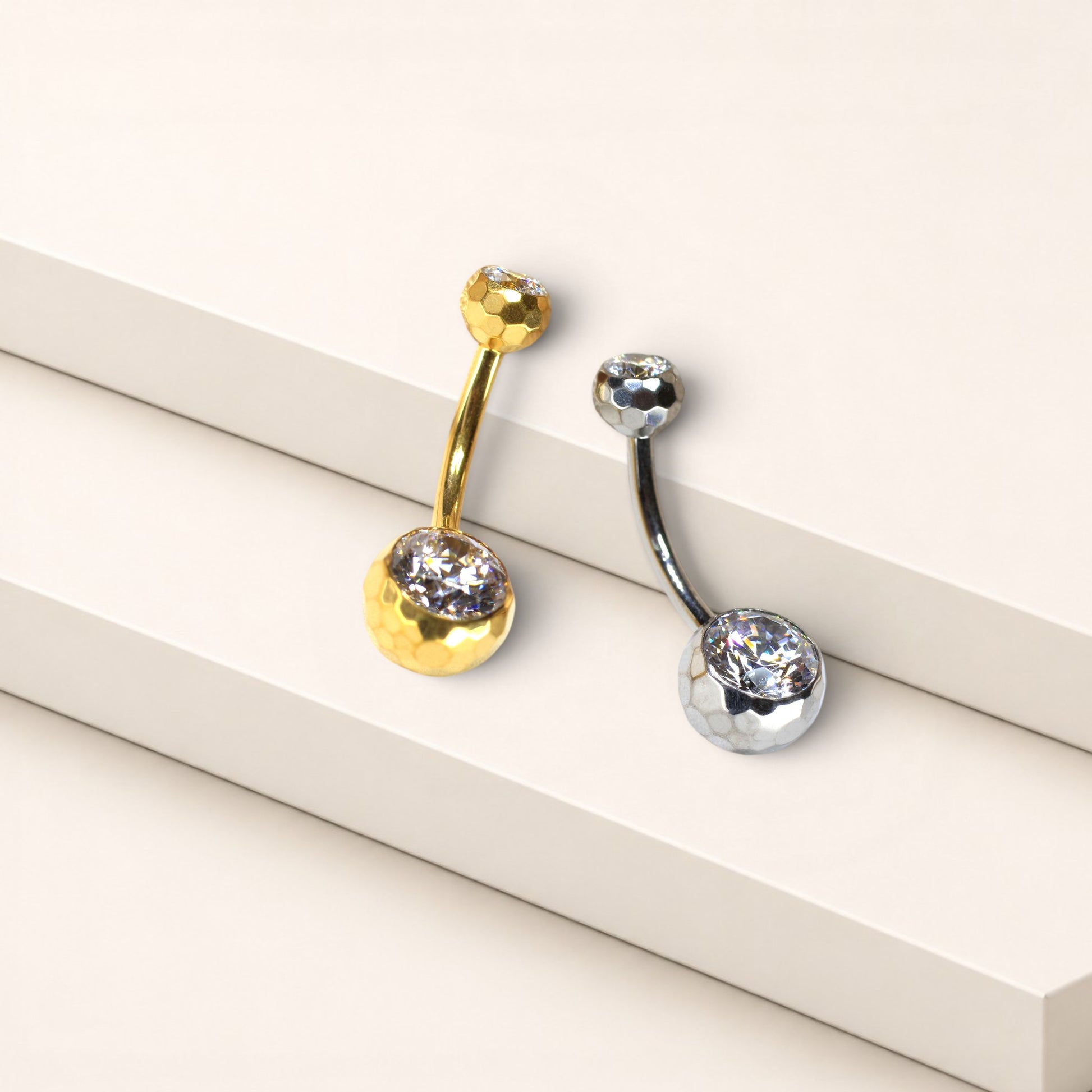 MKBodyJewelry 14g titanium belly button rings with faceted honeycomb settings and sparkling CZ stones in gold and silver.