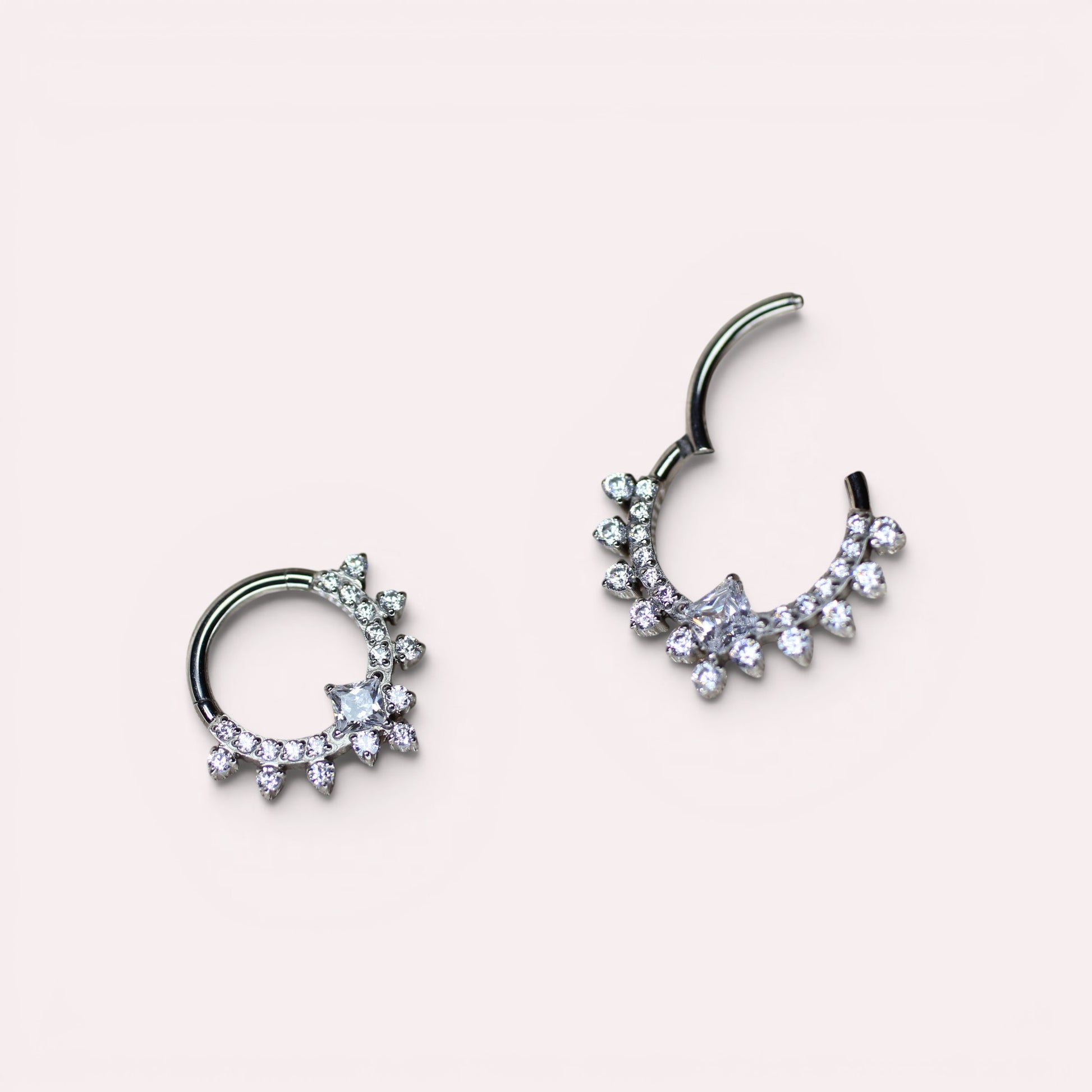 MKBodyJewelry silver titanium septum clicker ring featuring sparkling CZ crystals in a delicate sunburst design.
