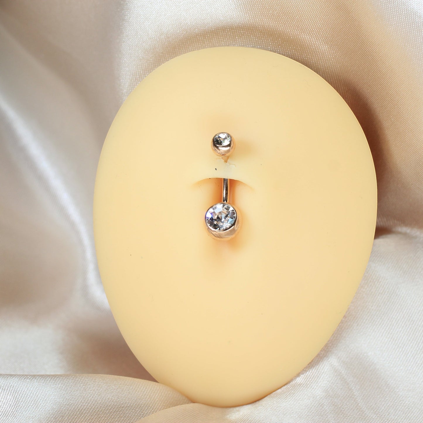 MKBodyJewelry titanium belly button ring with double clear CZ jewels in a honeycomb setting on a navel model