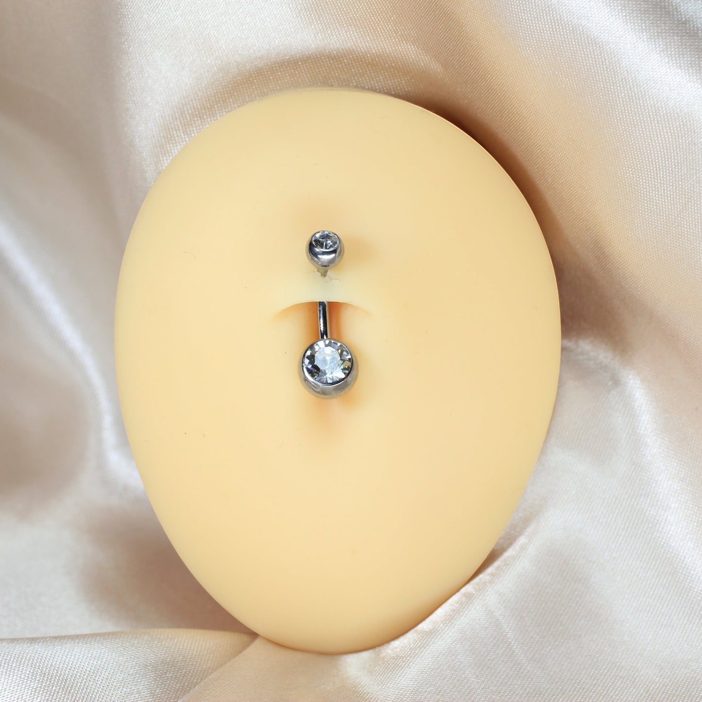 MKBodyJewelry titanium belly button ring with double clear CZ jewels in a honeycomb setting on a mannequin torso