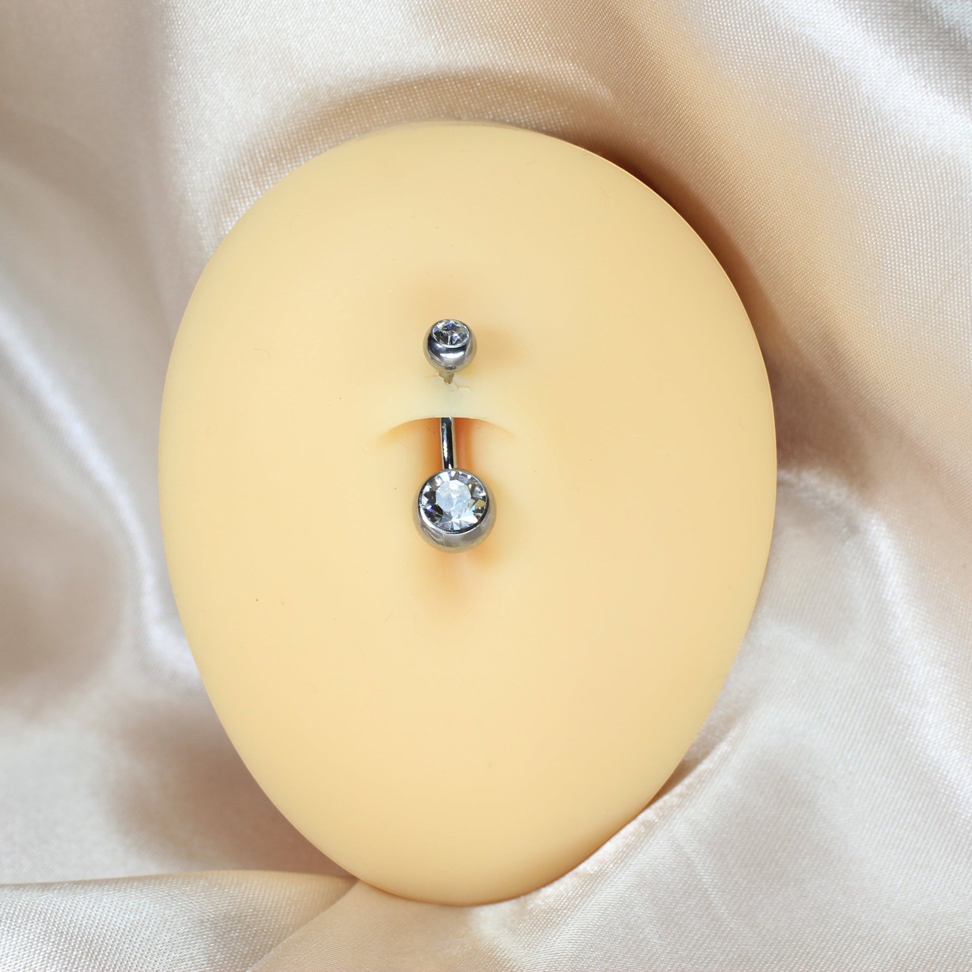 MKBodyJewelry titanium belly button ring with double clear CZ jewels in a honeycomb setting on a mannequin torso