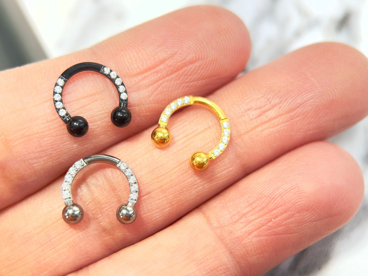 MKBodyJewelry Implant Grade Titanium Horseshoe Earring with pave CZ sides in black, gold, and silver.