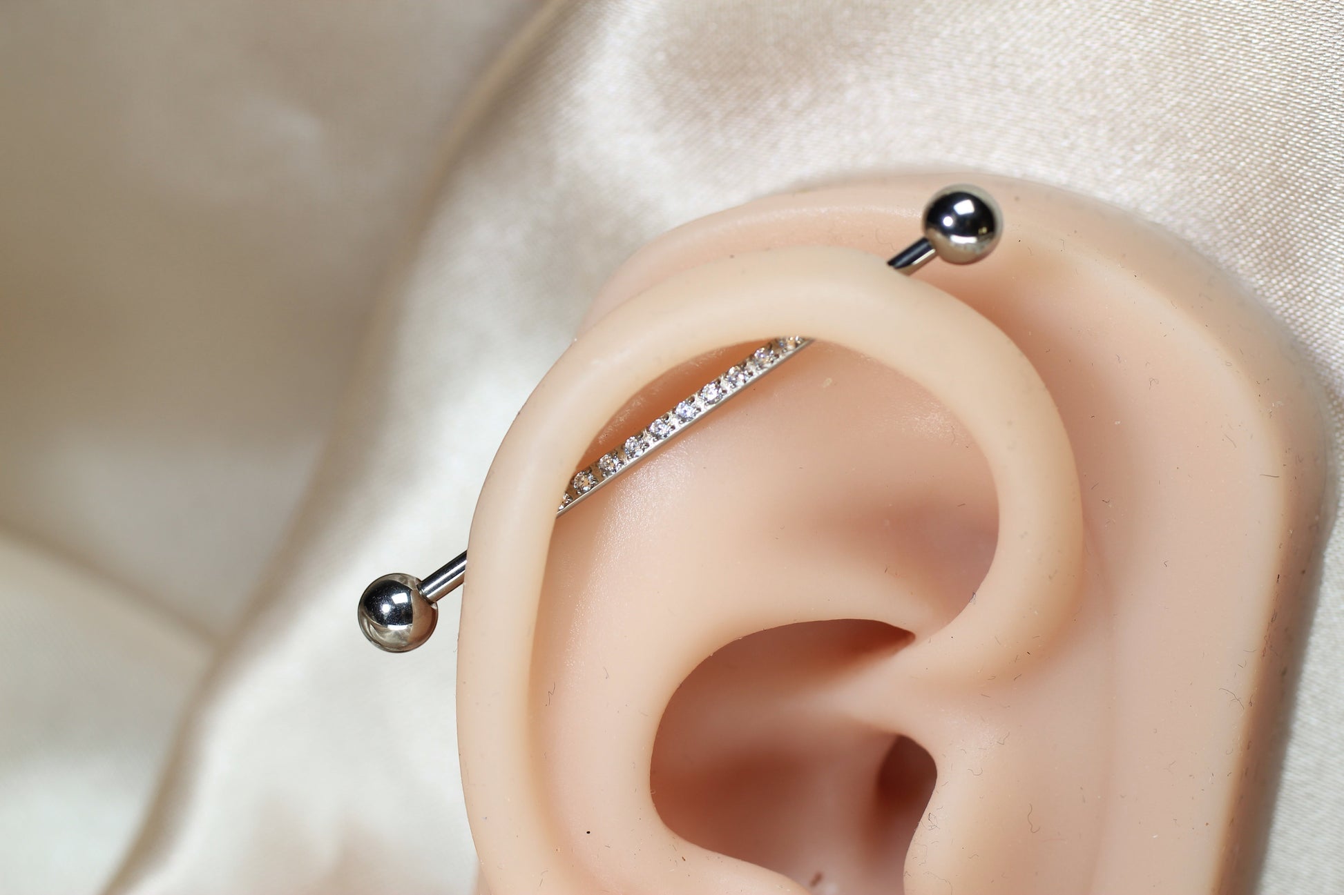 MKBodyJewelry 14G titanium industrial barbell with sparkling CZ gems. Externally threaded, 35mm length, 5mm balls.