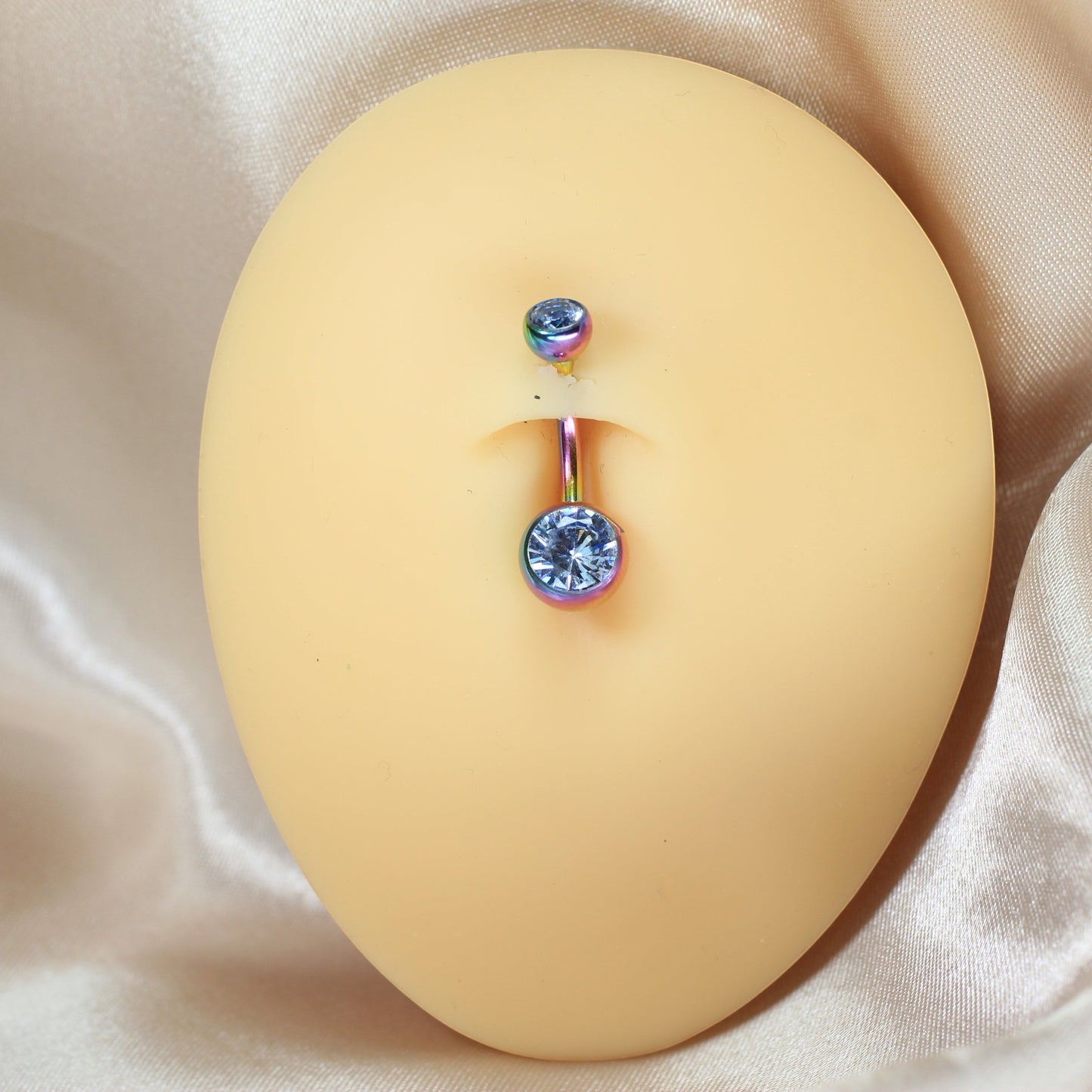 MKBodyJewelry internally threaded titanium belly button ring with iridescent rainbow finish and dual CZ jewels